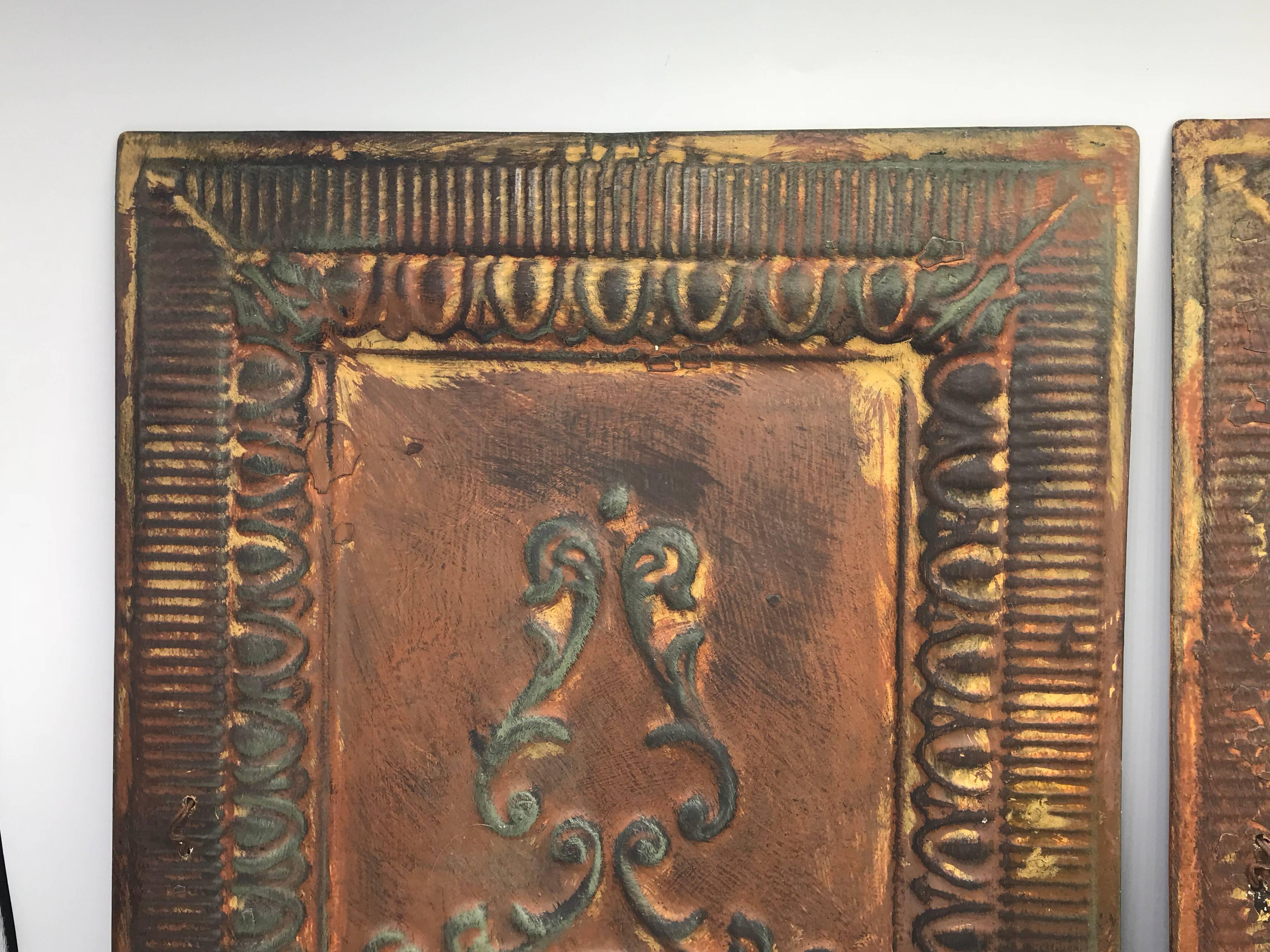 Listed is a stunning, pair of early 20th century architectural reclaimed raised-tin tole wall plaques. Beautiful, patina on all sides. Can be hung vertical or horizontal.