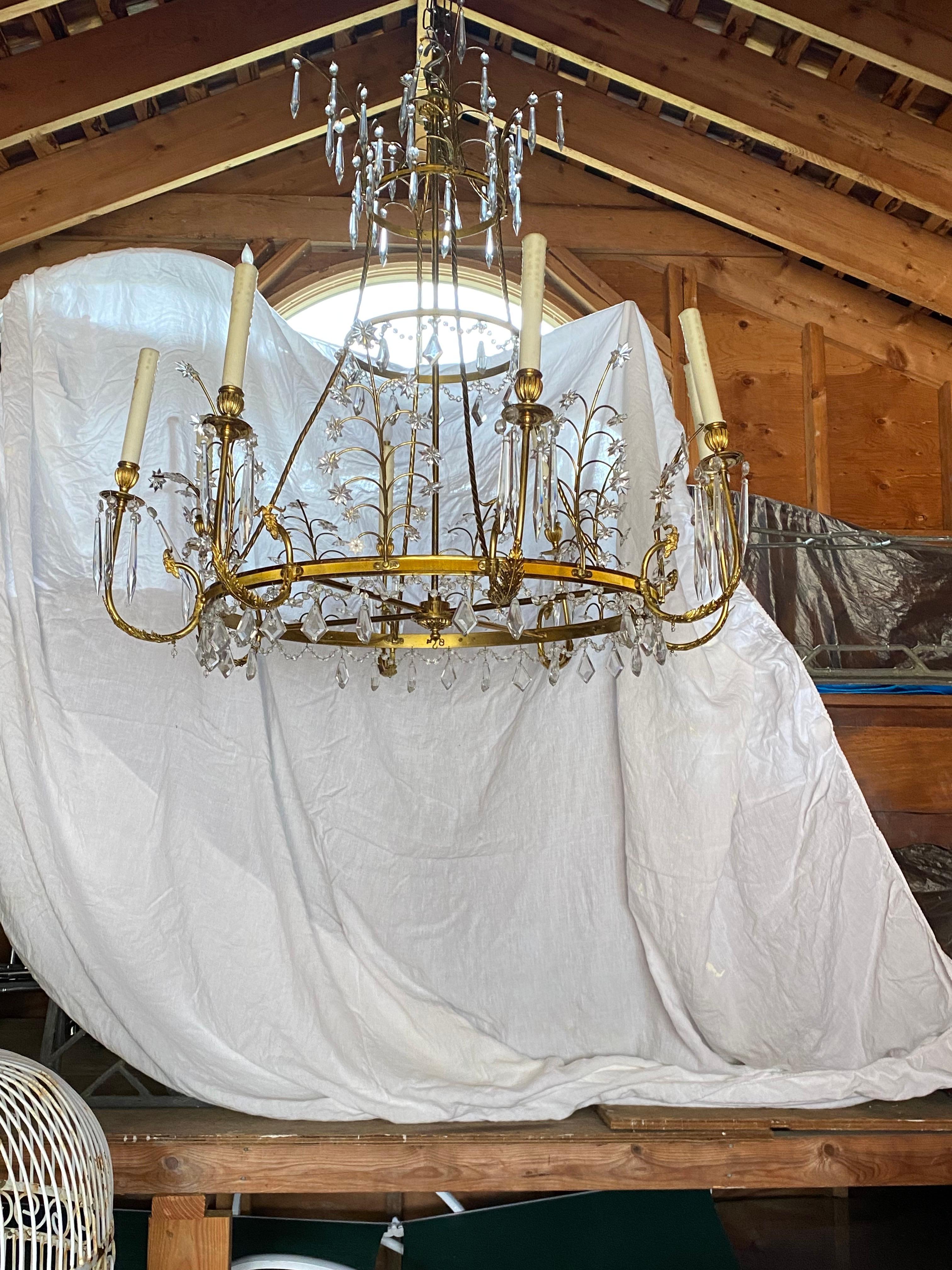 Early 20th Century Baltic Russian Neoclassical Brass & Crystal Chandelier.
A lovely delicate and sophisticated brass & crystal chandelier.  A grand scale with just the right amount of crystals: classic and refined. 8 arms, each candle has wax