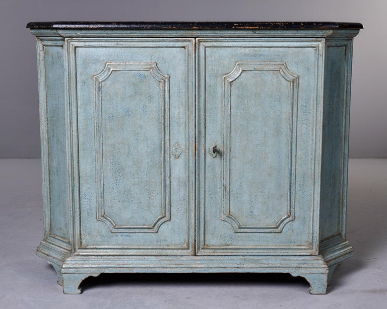 Circa 1910 French cupboard with two doors. Original lock and skeleton key are functional. Inside is painted with a single shelf. Footed base, contrasting black painted top. Unknown maker. Sturdy, quality construction. Versatile size. Unknown maker.