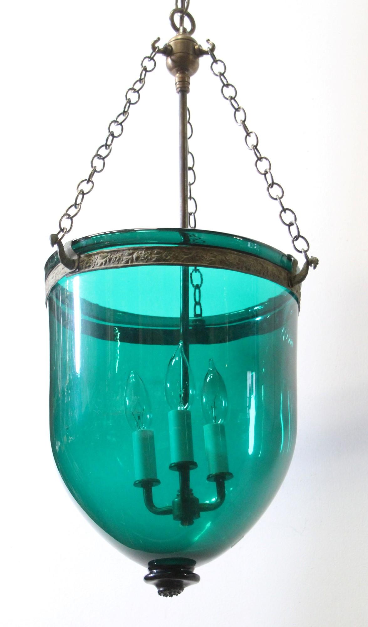 Early 20th Century European blueish green hand formed bell jar pendant light with new antique brass finish hardware.  This can be seen at our 400 Gilligan St location in Scranton, PA.