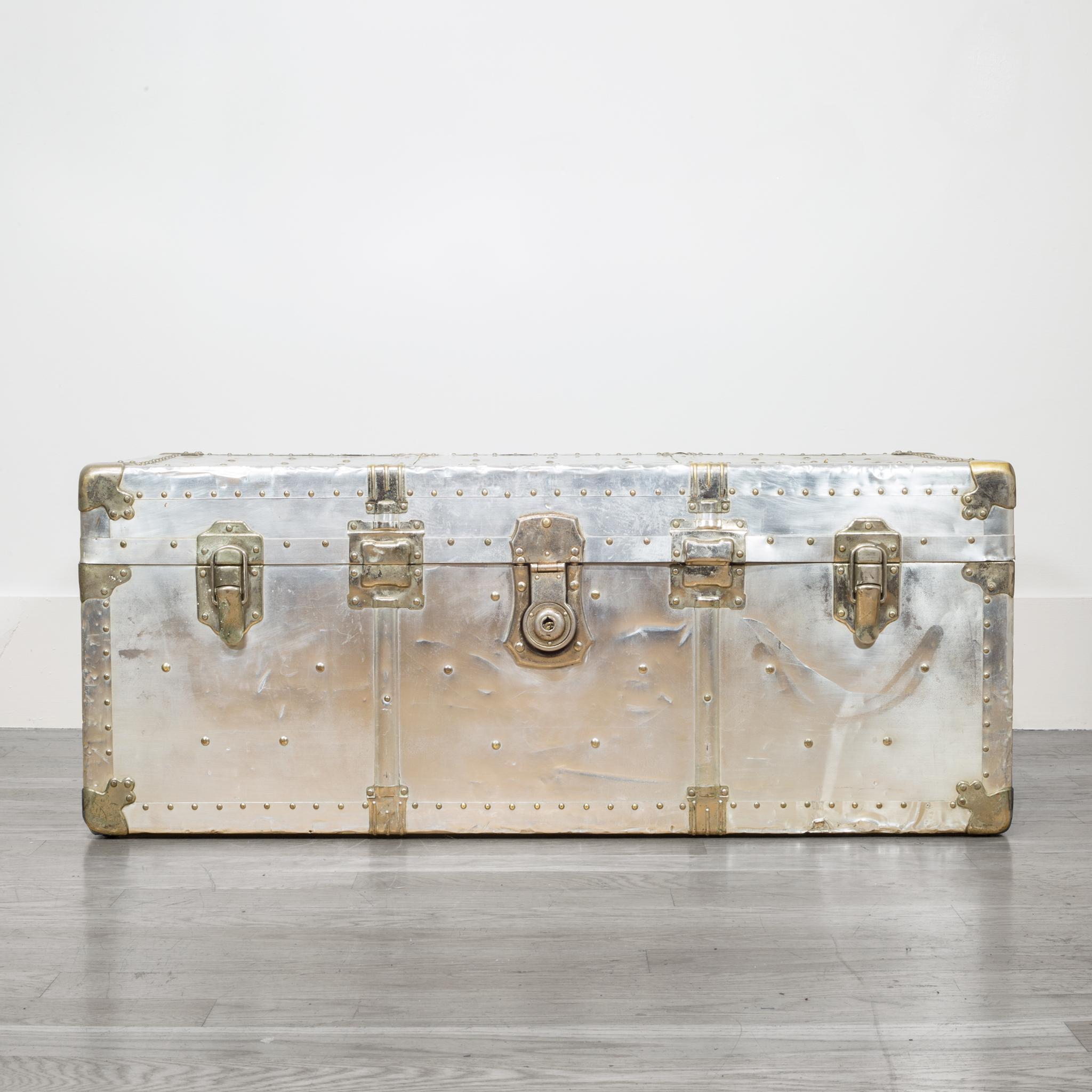 About

This is an original polished aluminum trunk with brass accents and leather handles. The interior is lined in fabric with a removable tray. The lock has 