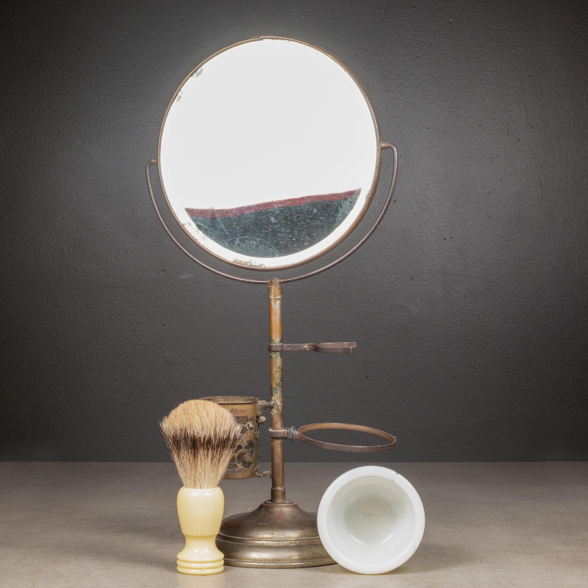 ABOUT

An antique brass plated shaving mirror and stand with the shaving brush, milk glass ceramic shaving soap cup, razor holder and beveled glass mirror. Badger hair shaving brush with Bakelite handle. Mirror tilts and swivels. 

Shown with life