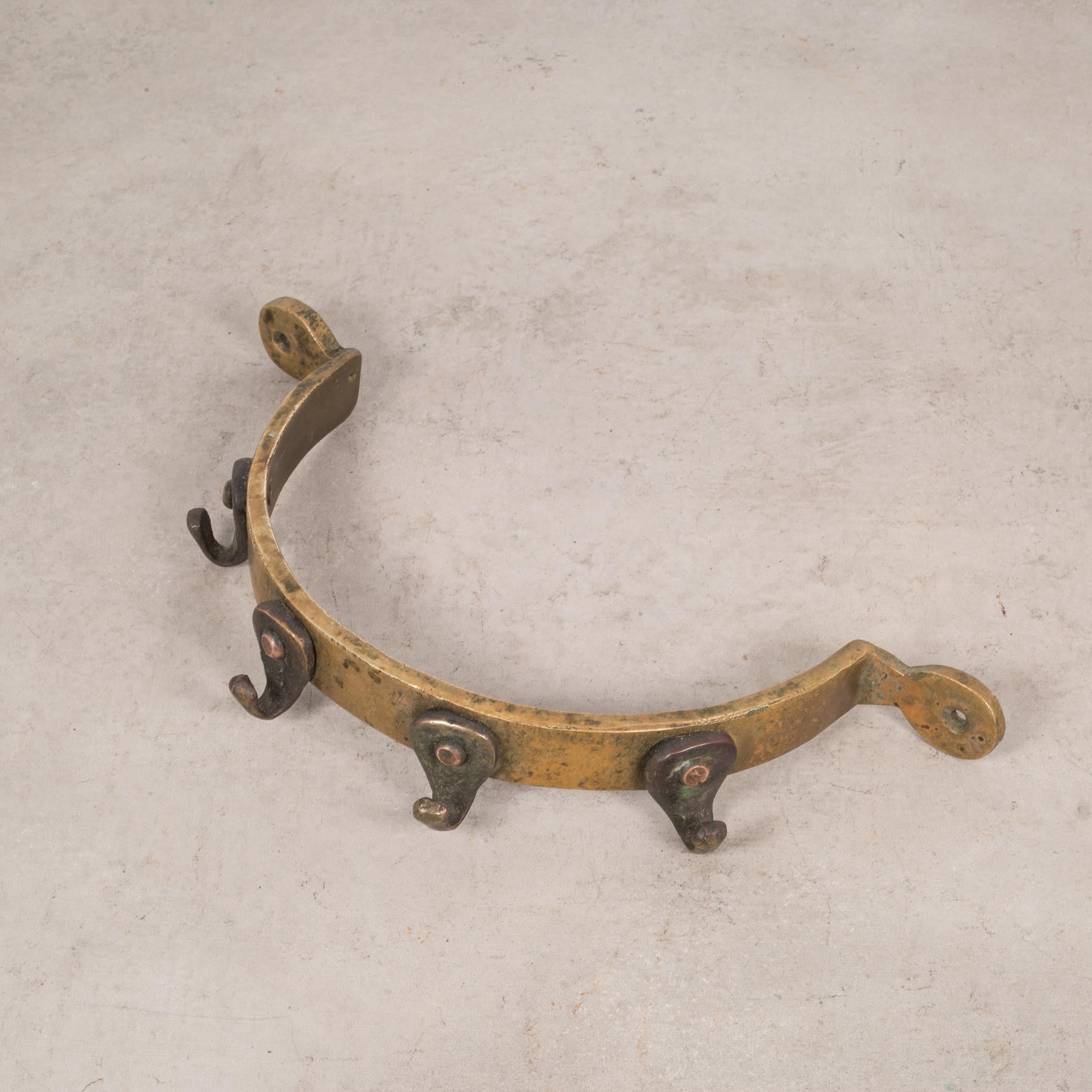 ABOUT

An antique bronze half circle pot rack with four copper hooks.

 CREATOR Unknown.
 DATE OF MANUFACTURE c.1900-1940.
 MATERIALS AND TECHNIQUES Bronze, Copper.
 CONDITION Good. Wear consistent with age and use.
 DIMENSIONS H 2 in. W 12