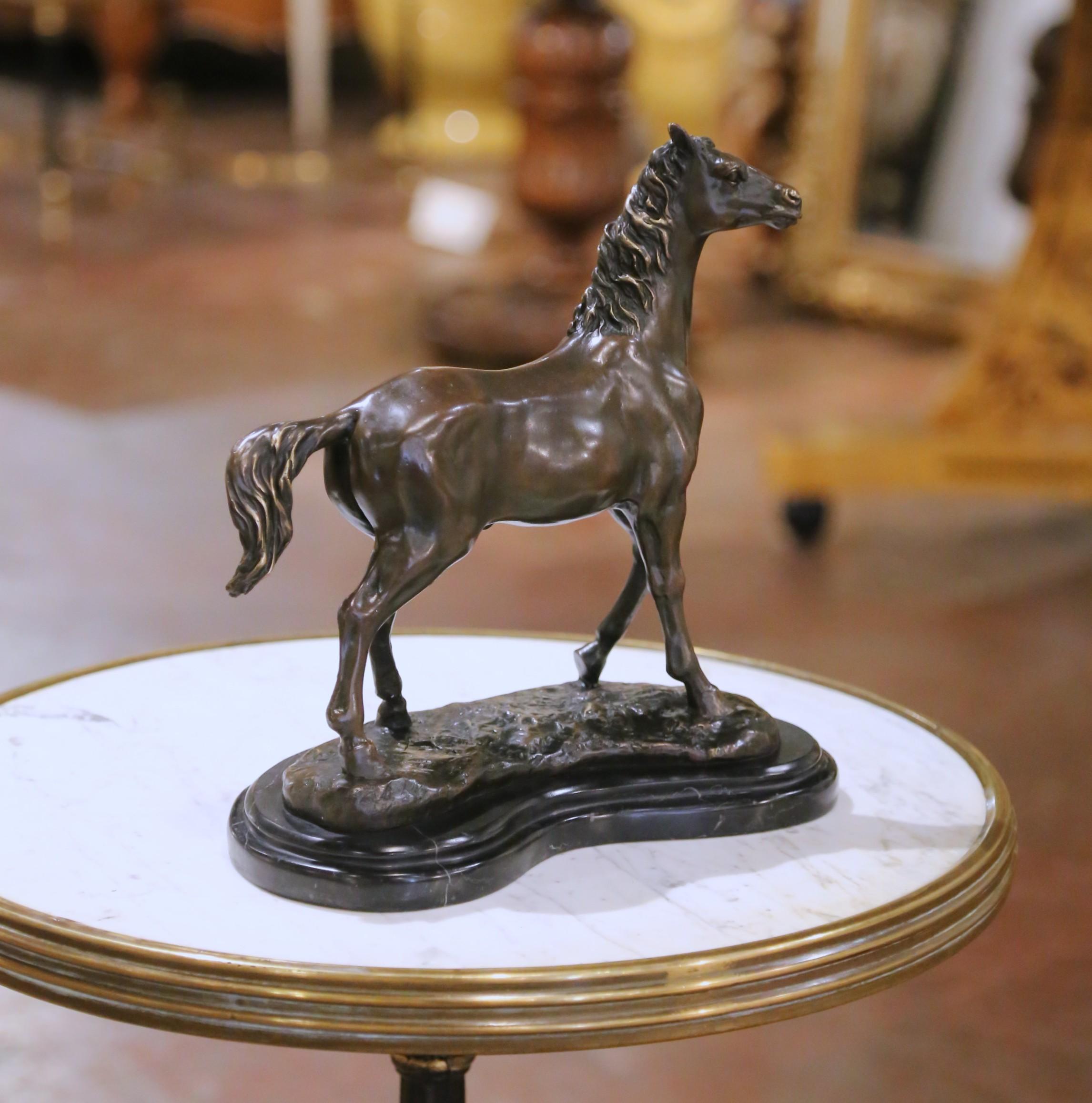 This elegant antique bronze sculpture of a standing horse was cast in France in the early 20th century and is signed “Milo” on the naturalistic base. The piece is mounted on a shaped black marble plinth and bears the foundry mark “Bronze Garanti