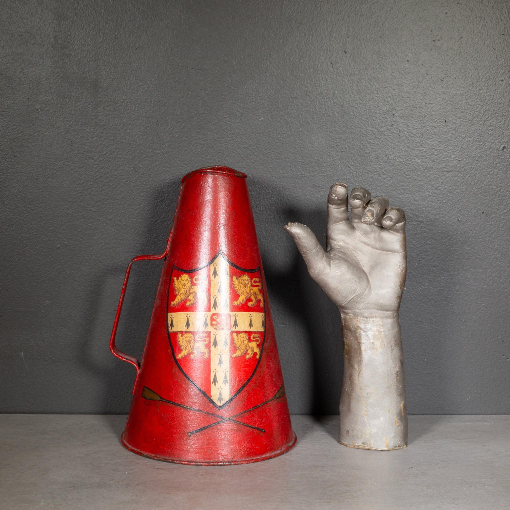 ABOUT

Cambridge University rowing team megaphone with some old restorations.

Shown with life size hand model for scale. 

    CREATOR University, United Kingdom. 
    DATE OF MANUFACTURE c.1920-1940. 
    MATERIALS AND TECHNIQUES Hand Painted