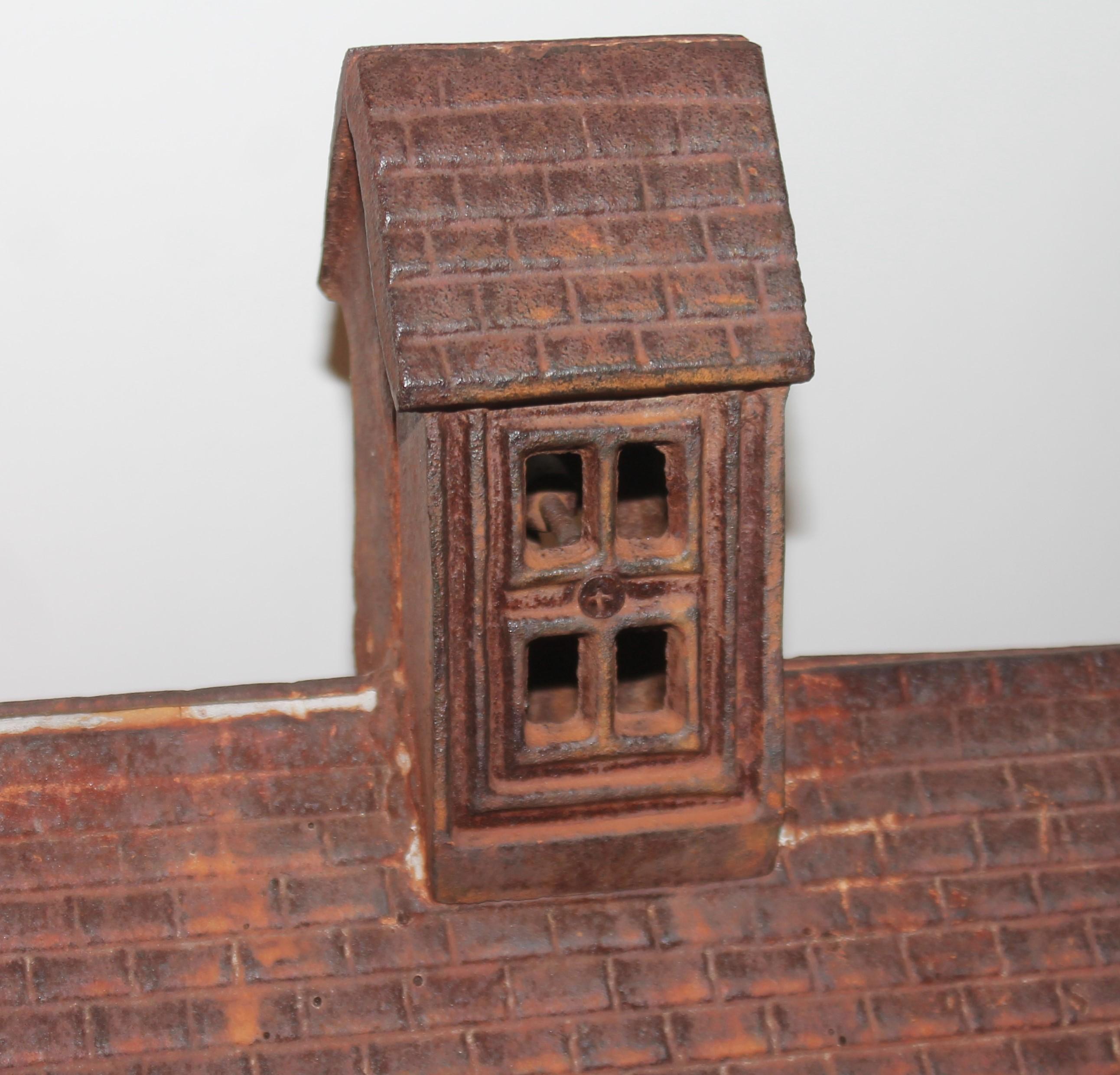 Early 19th C cast iron miniature farm house. Rust surface patina. From New England.