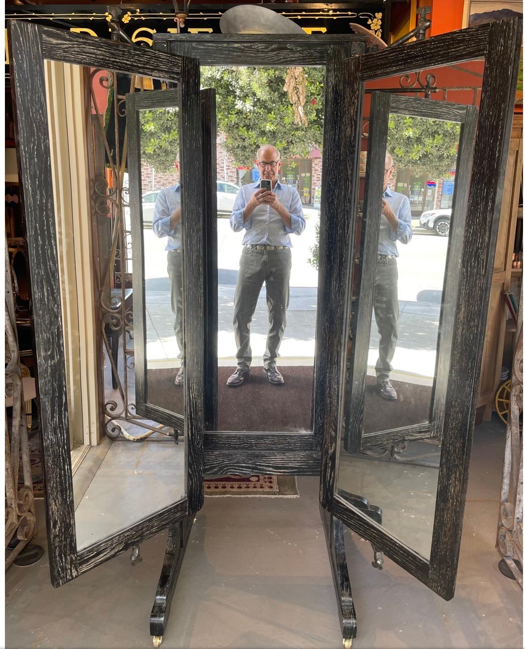 This is quite possibly one of the coolest pieces I have ever had. It started out its life as an oak dressing mirror from a haberdashery. I have recently had it cerused black and white. The mirrors on the sides pivot within their axis and the frames