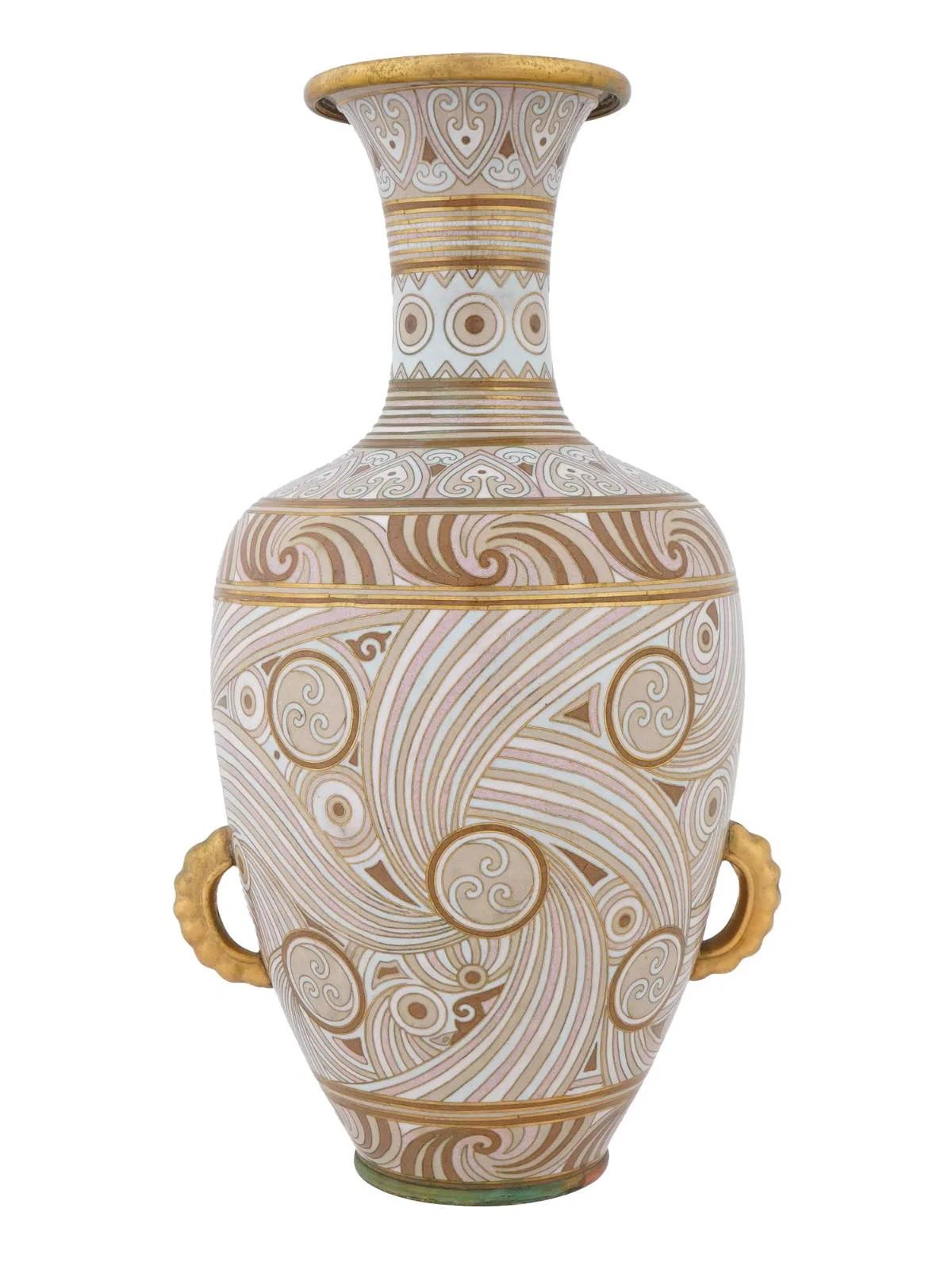 An early 20th century Chinese copper vase with cloisonne enamel decor. Bottle shape. Swirl ornamental design in beige color palette. Gilt rims and side handles. Collectible Oriental Asian Decor.

 
Dimensions
H 15 1/4 in. Top D 4 1/2 in. All