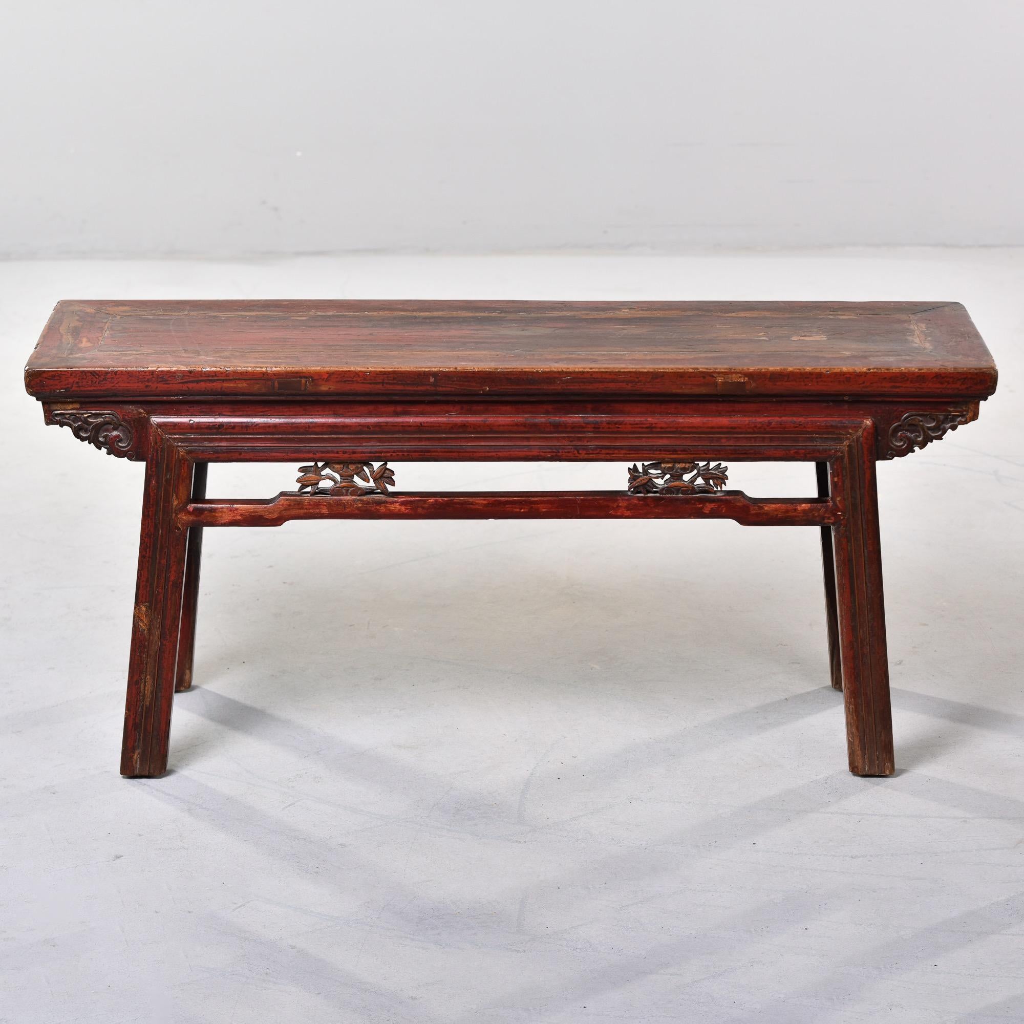 Circa 1900 Chinese elmwood bench from Don Yang City, China with carved details on stretcher and side supports. Great color and patina. Sturdy.