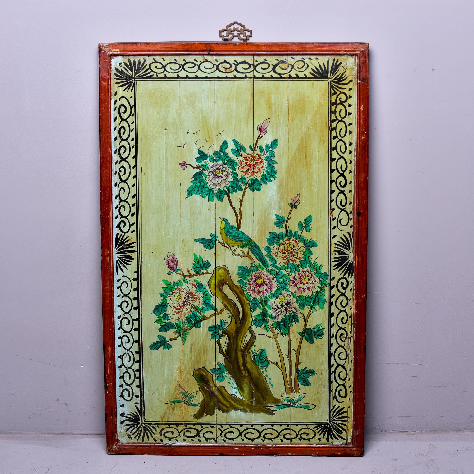 Circa 1900 Linhai wood panel with hand painted scene in green and fuchsia tones of a flowering tree with a bird. Painted black scrolled border and red edge. Decorative brass hanger at the top. 

Panel measures 38.5” high without brass hanging