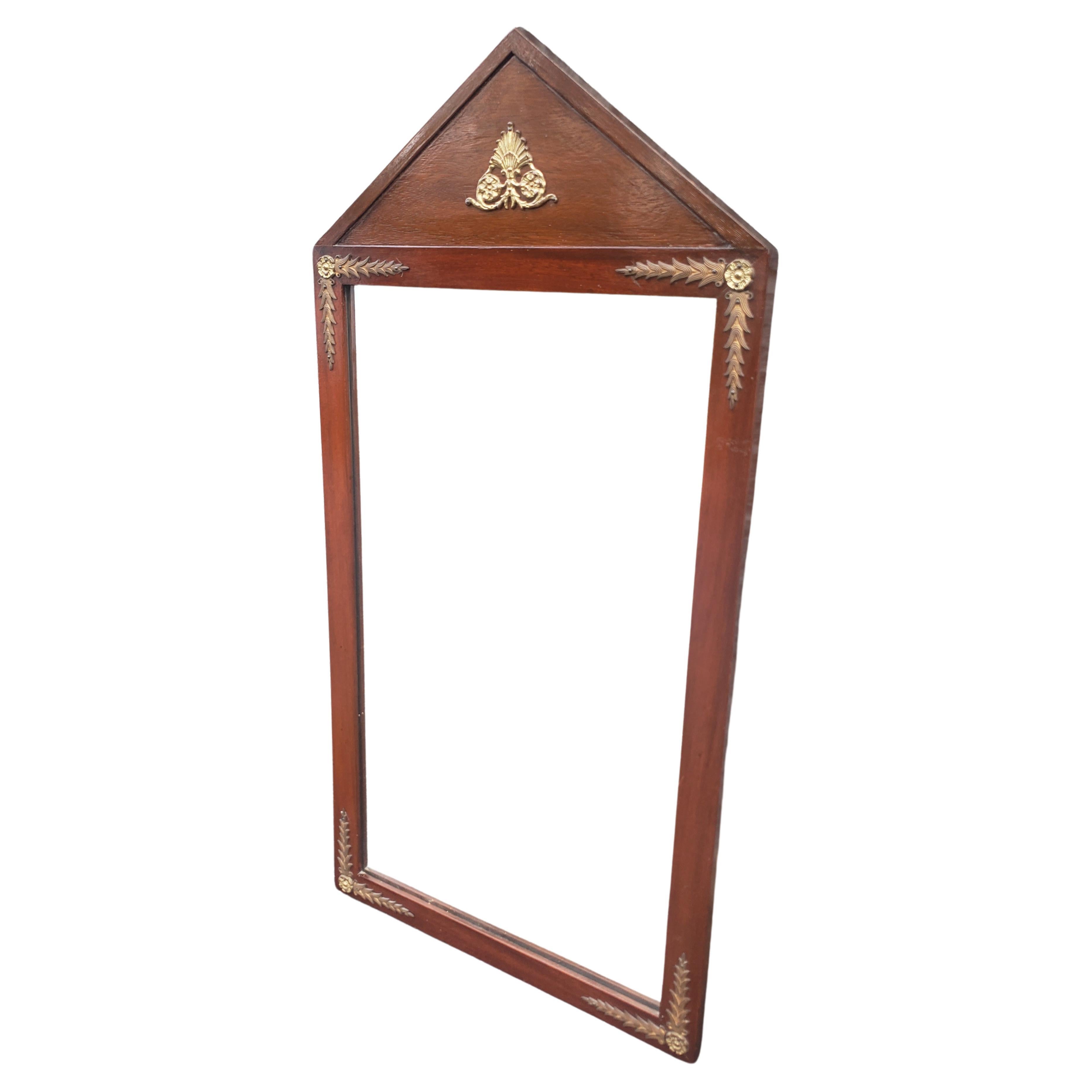 An Early 20th century Empire Neoclassical Brass Mounted and Mahogany Wall Mirror in good condition. Solid Mahogany frame. Measures 18