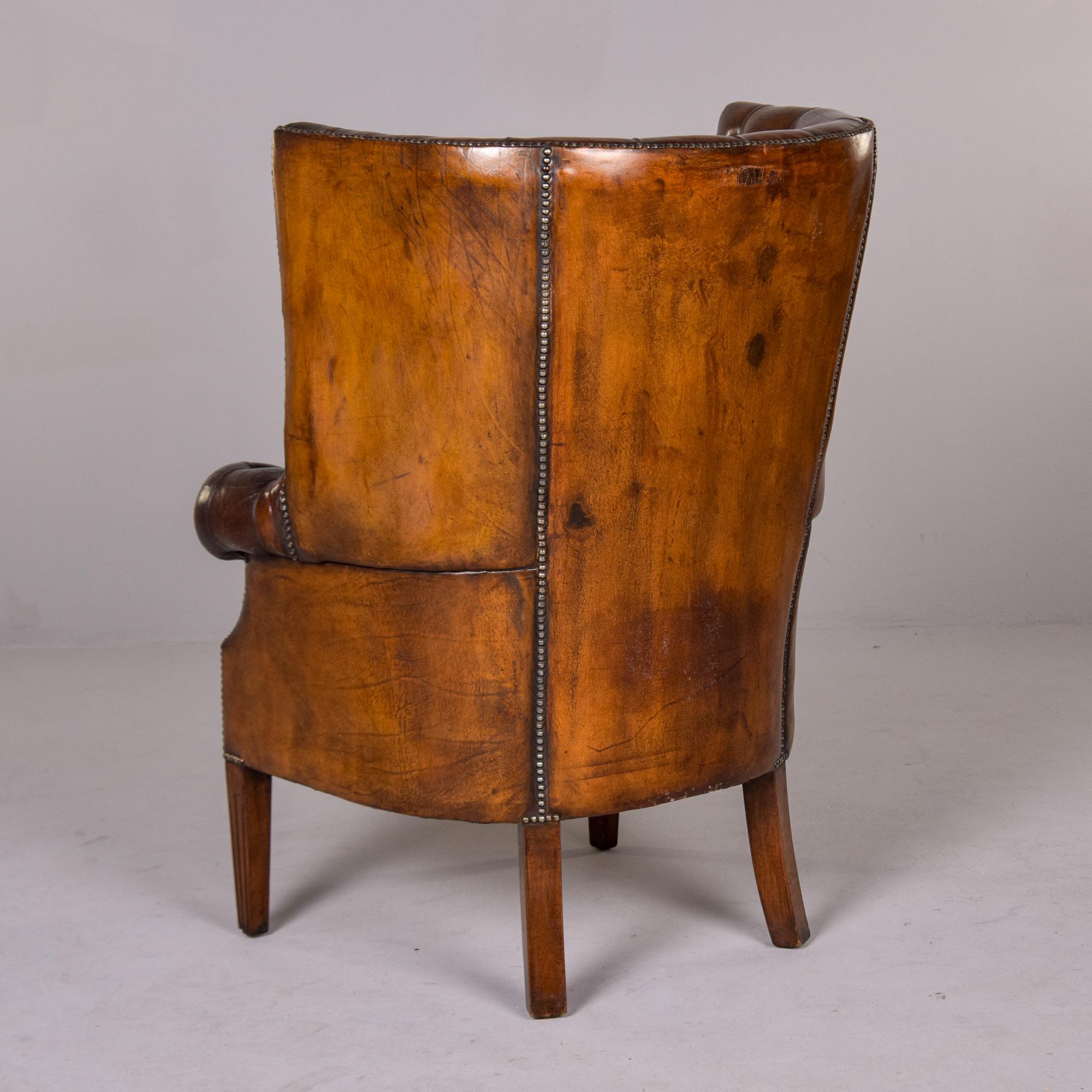 Brass Early 20th C English Button Tufted Leather Wing Back Library Chair For Sale