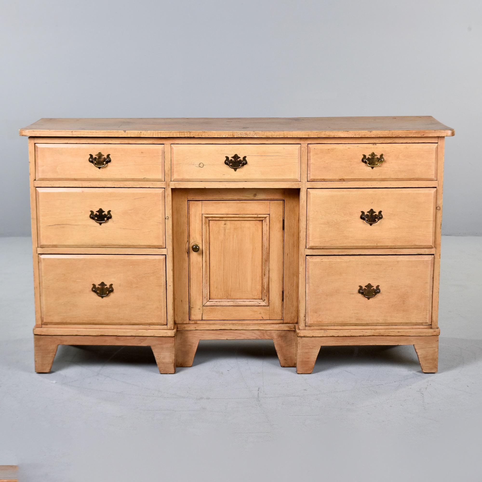 Found in England, this Chippendale style chest dates from approximately 1915. This pine is its natural color with a clear, satin finish. Original brass hardware. Seven functional drawers - one at top center flanked by a stack of three graduated size