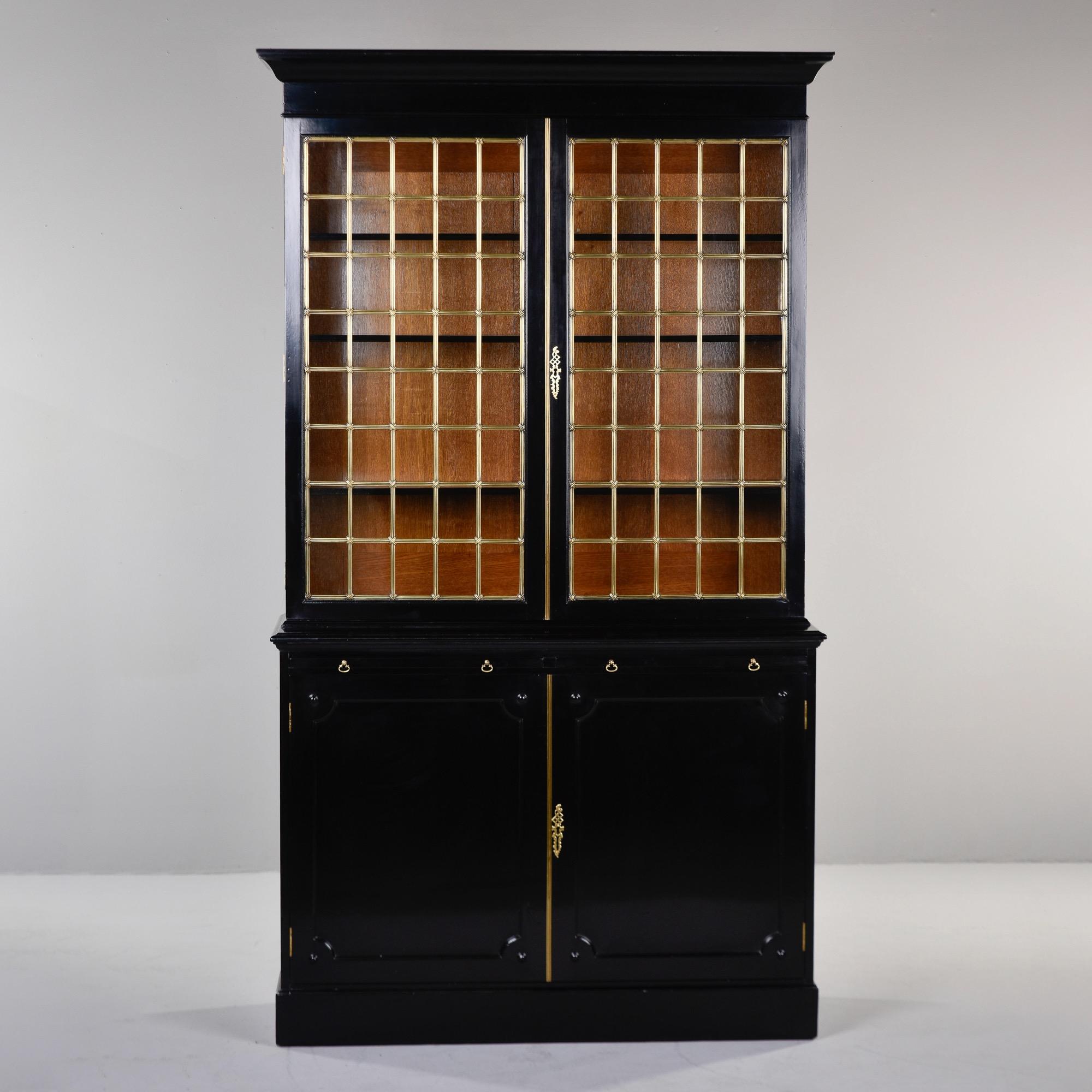 Found in England, this mahogany bookcase cabinet dates from approximately 1900. We had the piece ebonised in England by professionals and left the interiors in the original stained mahogany finish for contrast. The top section can be removed from