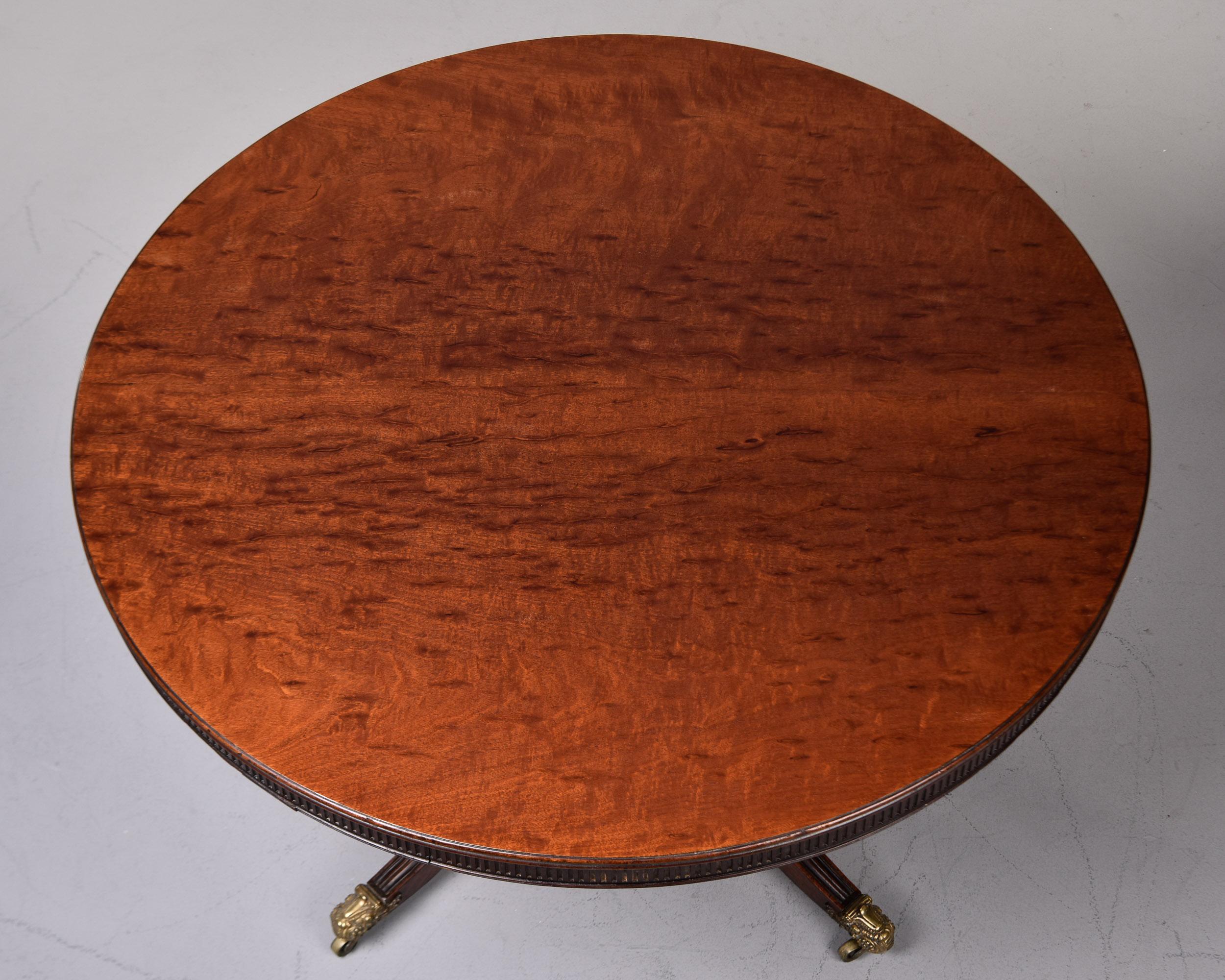Found in England, this mahogany pedestal table is just over 48” in diameter and dates from approximately 1920. Top has been newly refinished with a satin finish and features a carved and reeded band around the outside edge.  Base has four legs with