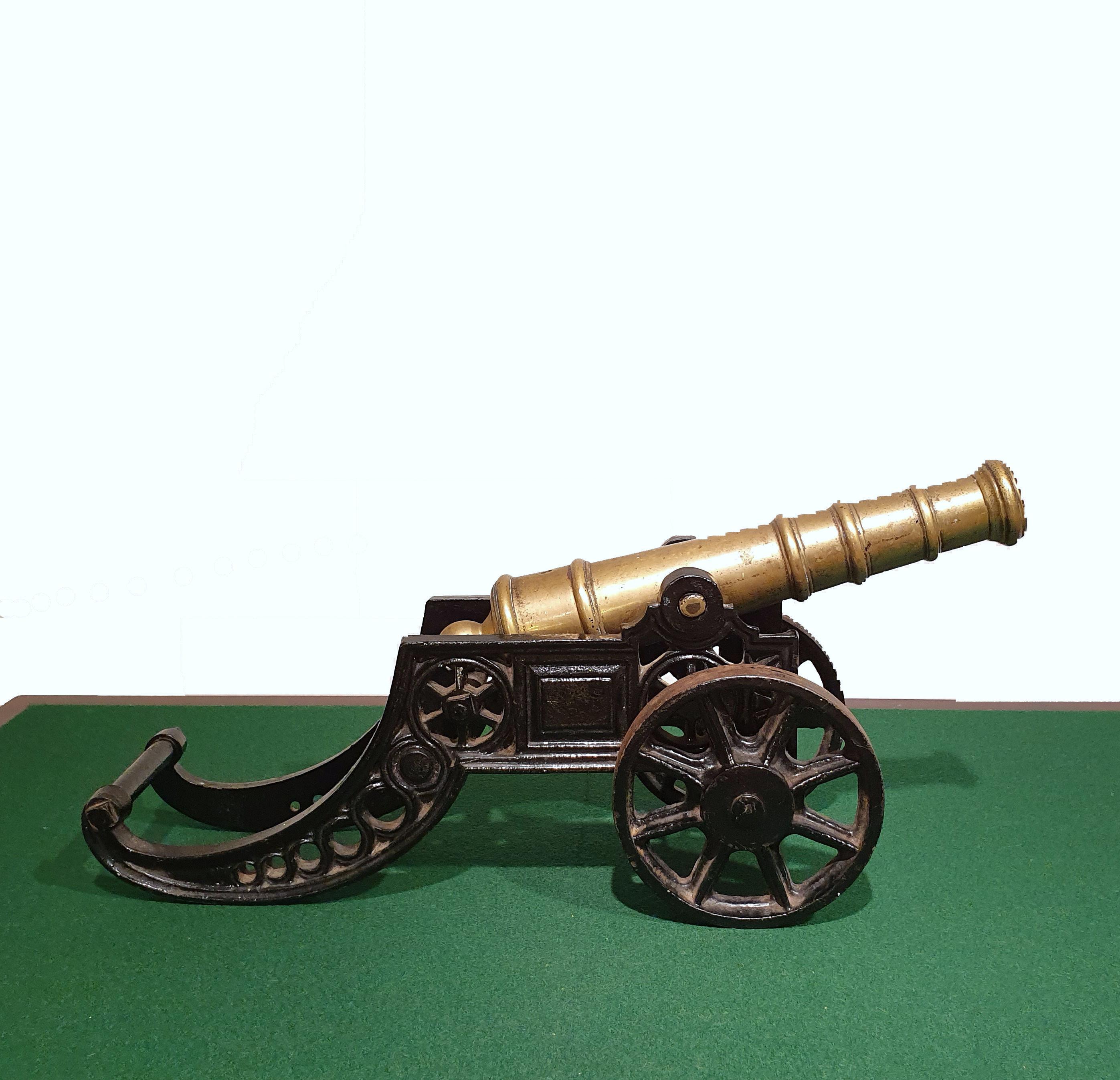 This well-proportioned to scale and detailed cast iron model of an English starting cannon features movable parts including the wheels and cannon barrel. It includes excellent detailing work, and a lovely worn patina, to commensurate with age. It