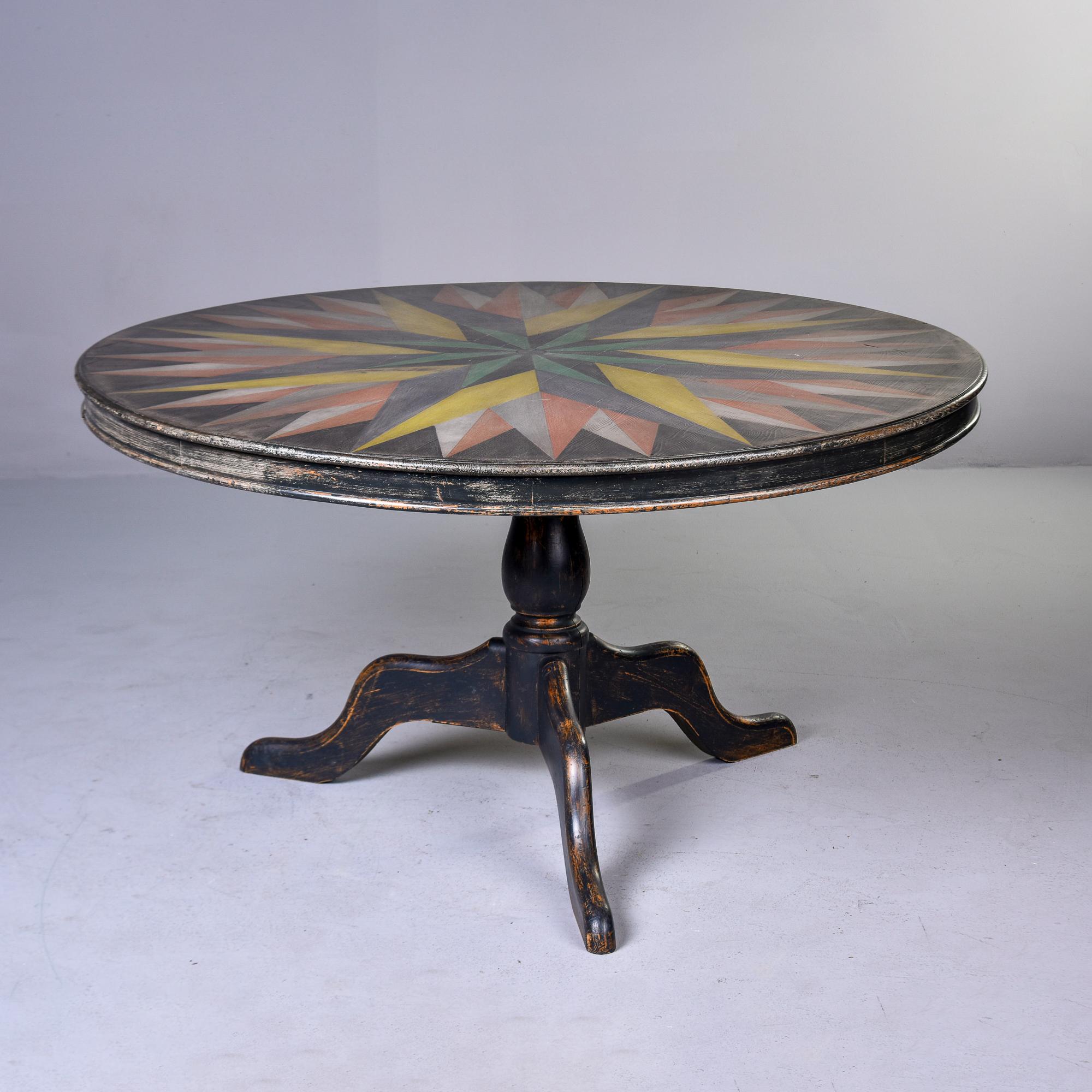 Found in England, this round pedestal table dates from approximately 1900. Table features a tri-foot pedestal base, turned center support, rand a ound top that is 53-1/2” diameter. Table has a soft black painted finish with a multi-color,