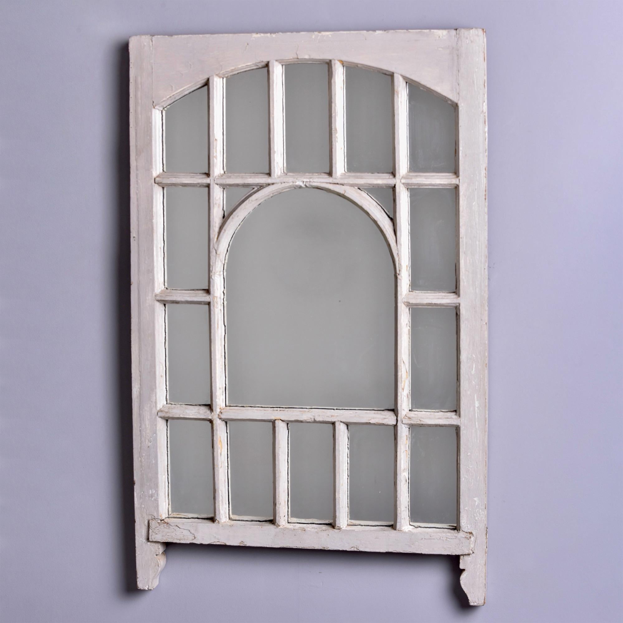 Found in England, this circa 1900 wood window has been painted off white and now frames a mirror. Arched center with rectangular panes that arch at the top. Two mirrors available at the time of this posting. Priced and sold individually.