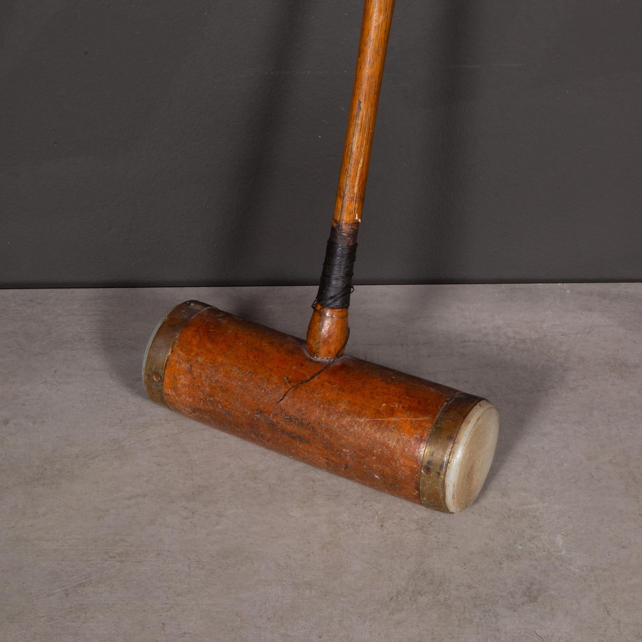 ABOUT

A brass and wood British croquet mallet engraved with 