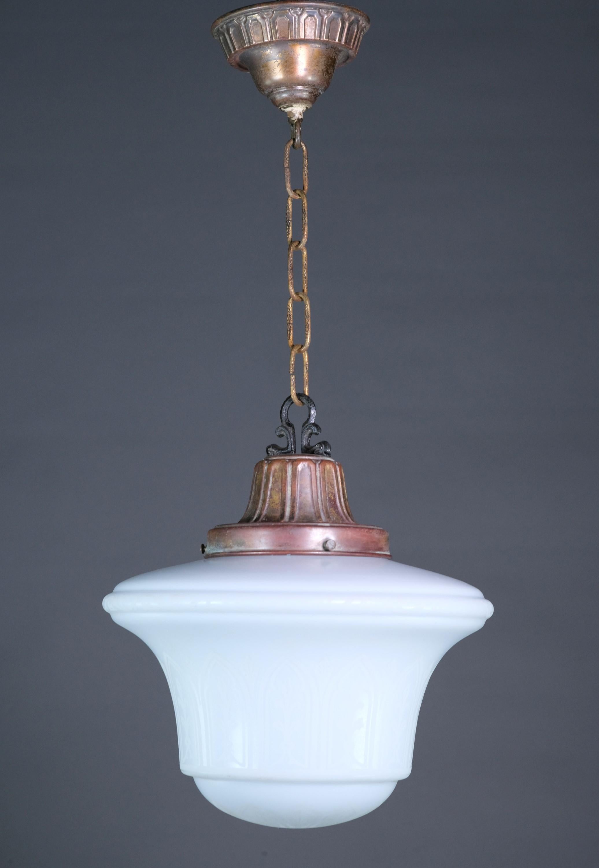 Single pendant light featuring an etched arched Gothic design on the white shade. Original brass fitter and iron hardware. This can be seen at our 400 Gilligan St location in Scranton, PA.