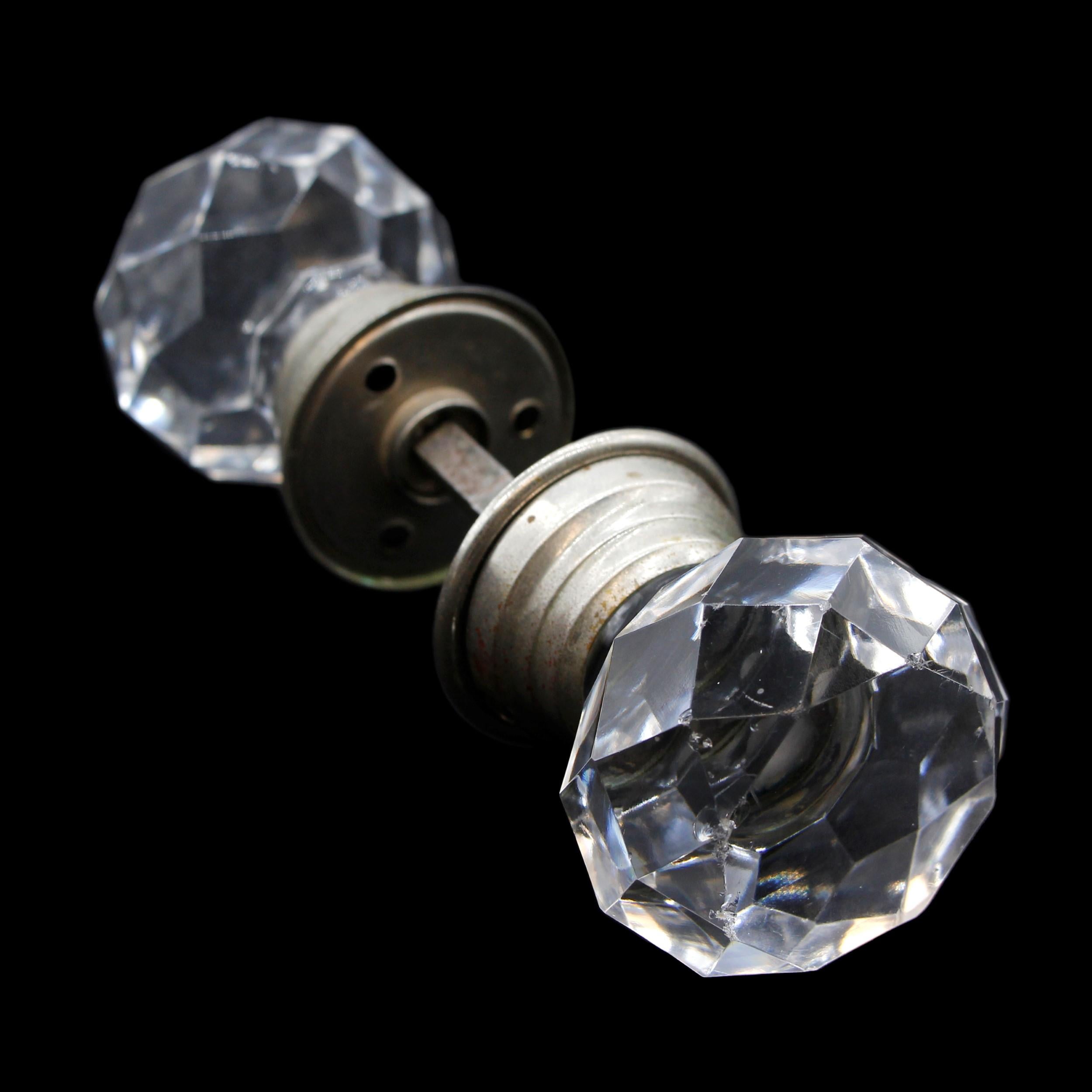 Very rare early 20th Century faceted glass antique doorknob set with nickel plated brass rosettes. Reminiscent of a diamond. Priced as a set. This can be seen at our 400 Gilligan St location in Scranton, PA.