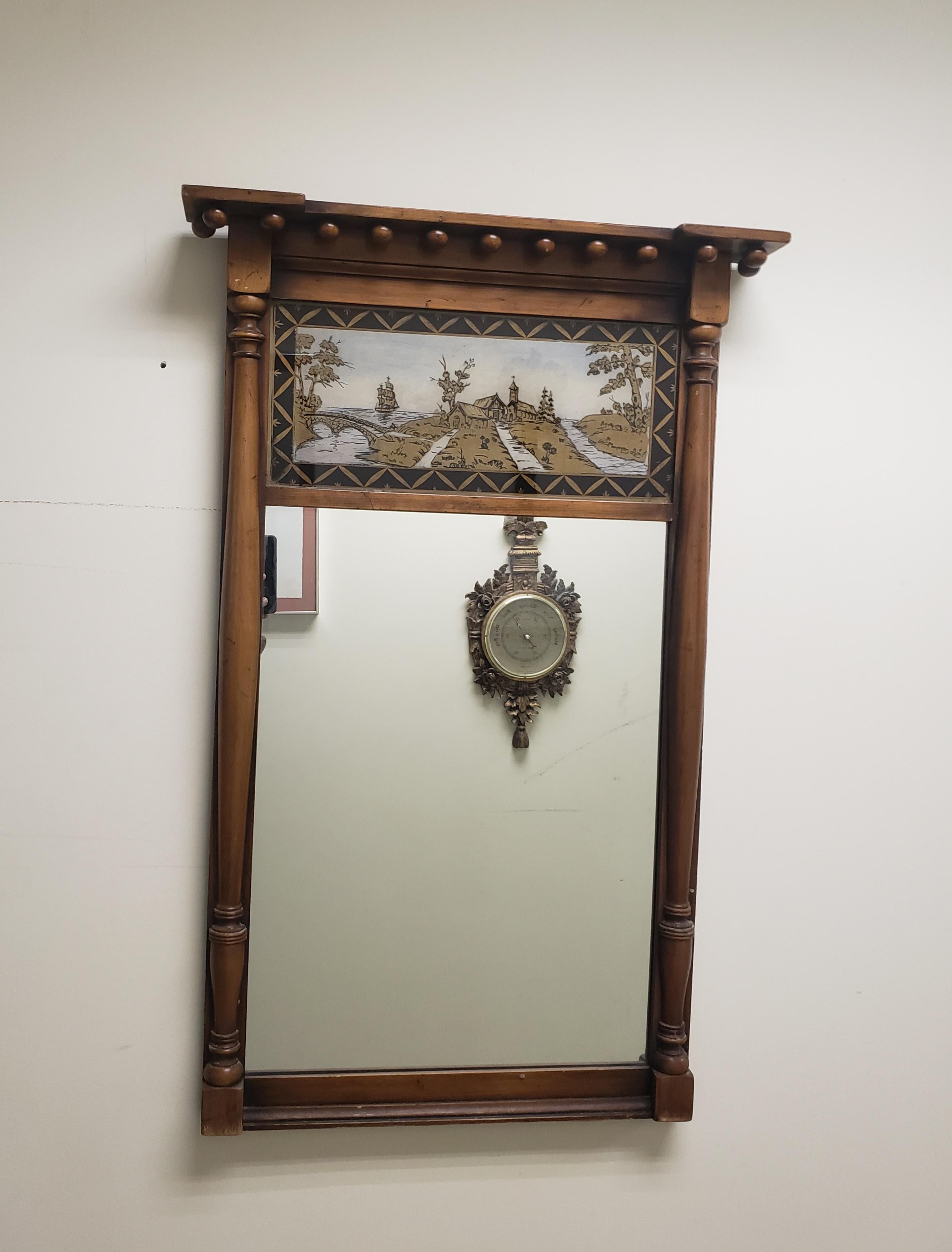 Beautiful early 20th century Federal style mahogany and Eglomise wall Trumeau mirror. Measures 24.25