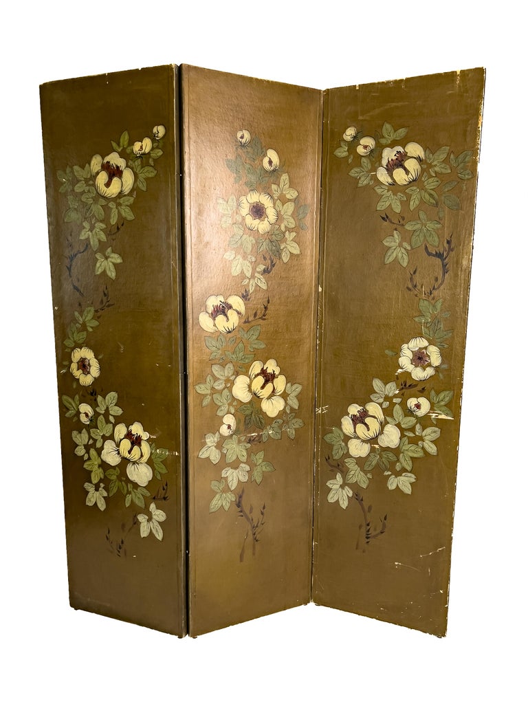 Early 20th century Floral 3 panel Folding Screen. Burnished gold color with trailing leaves and flowers. This piece also has d-rings on the back, giving you the option to mount it.