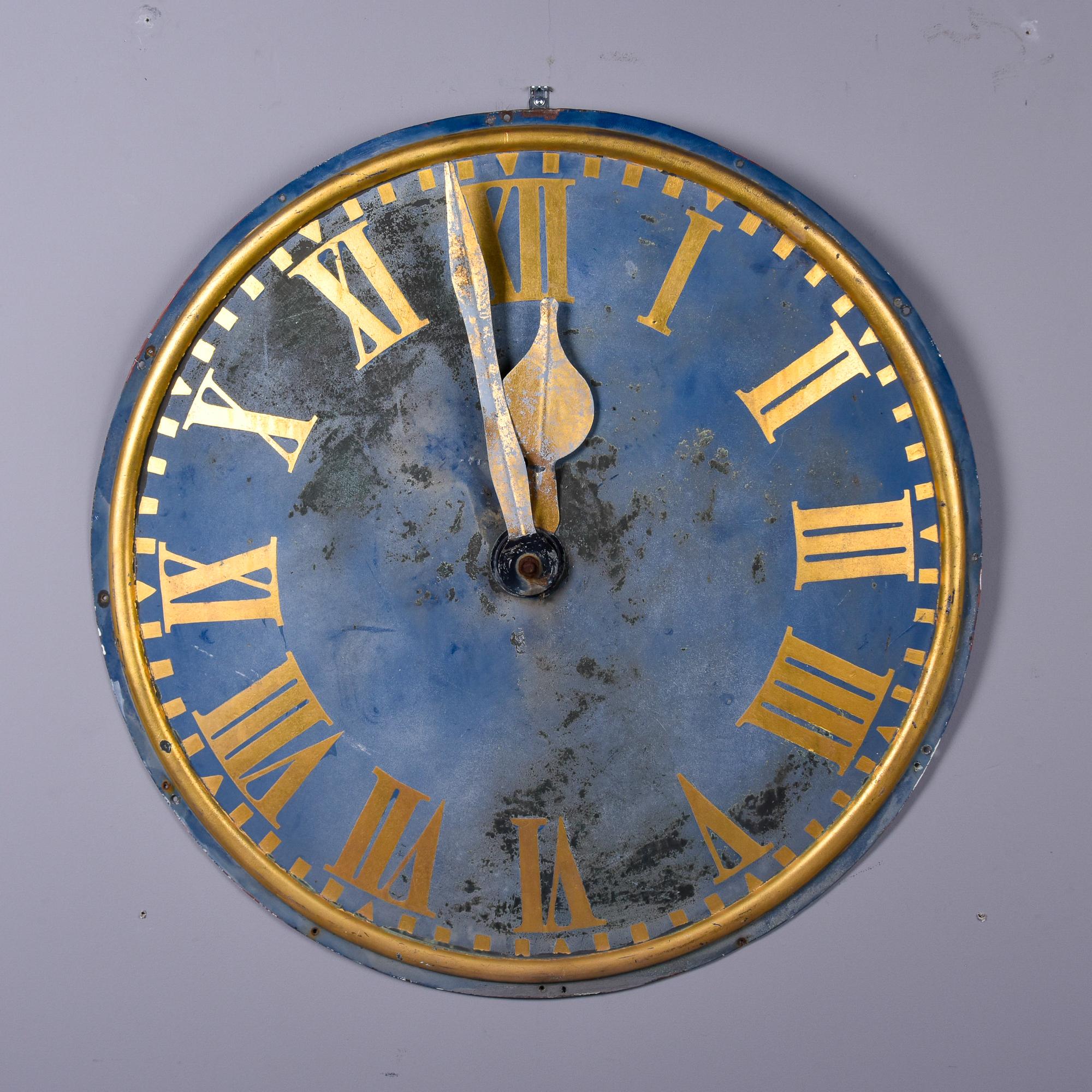 Found in France, this circa 1900s metal clock face with gray blue paint makes a great wall display. Original metal clock face is 36” diameter and appears to have had the gold paint touched up - we found it as shown. Unknown maker.