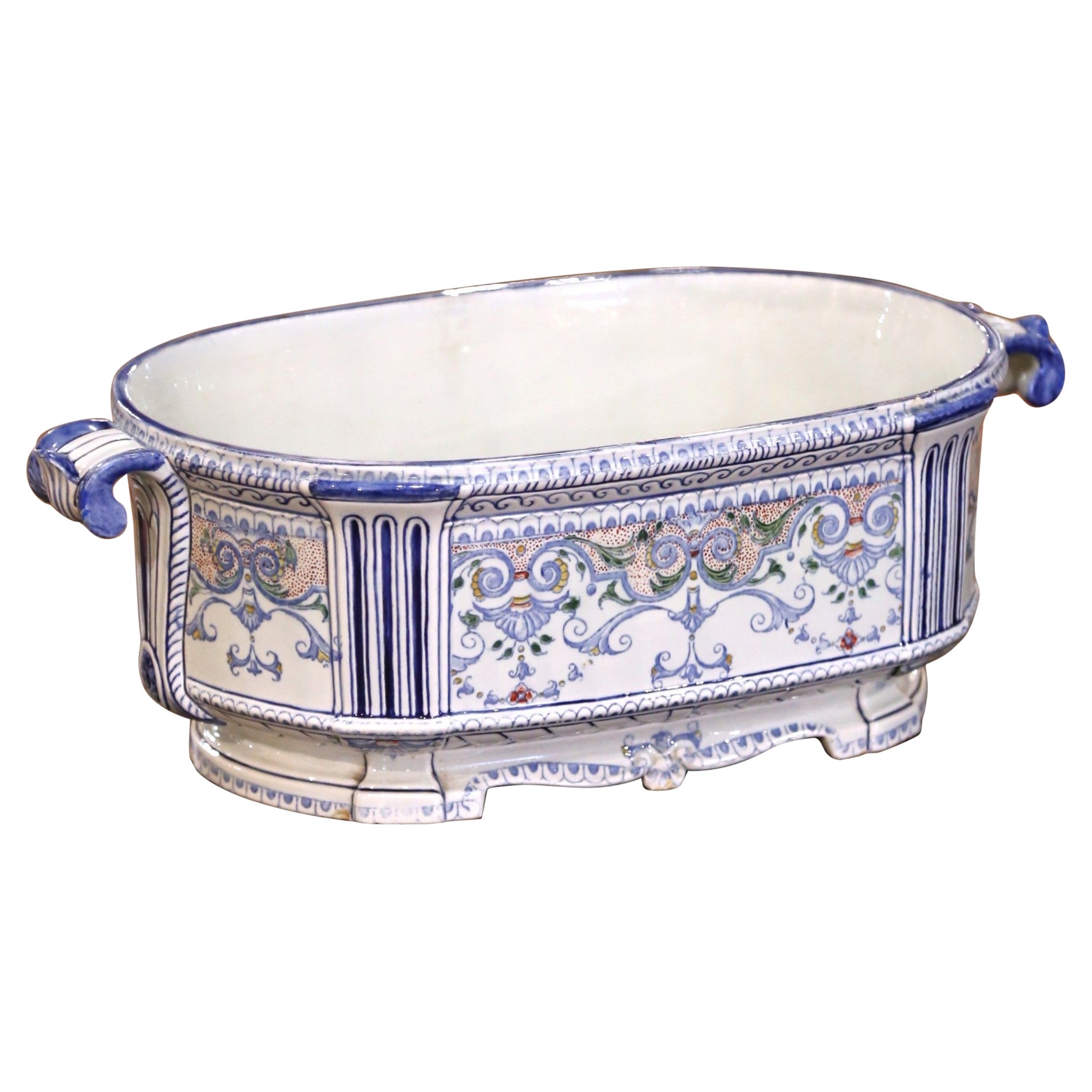 A.I.C. Jardinière en faïence de Desvres avec poignées en forme de masques et rinceaux.