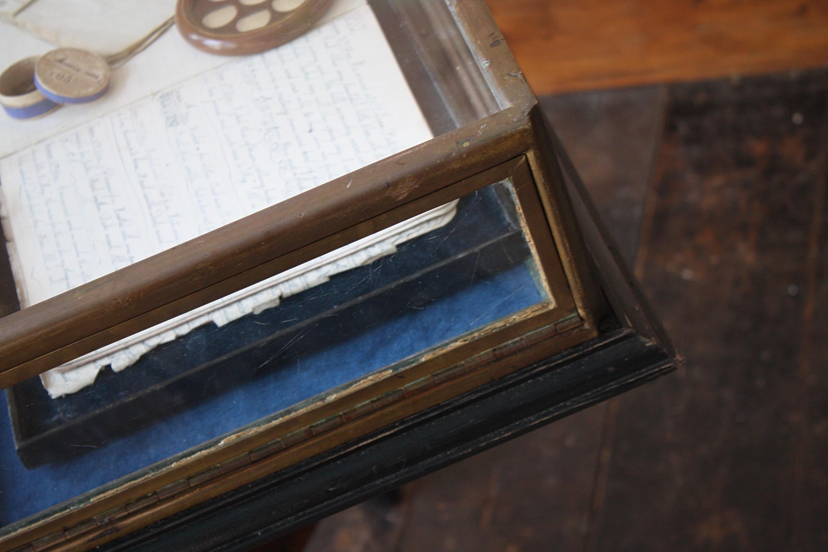 An extremely good quality heavy gauge bronze table top display case, produced by Mallard Valenducq & Dubois of Paris. Likely to of been for fine jeweller with the internal removable slips. 

Unfortunately the key has long been mislaid, but the