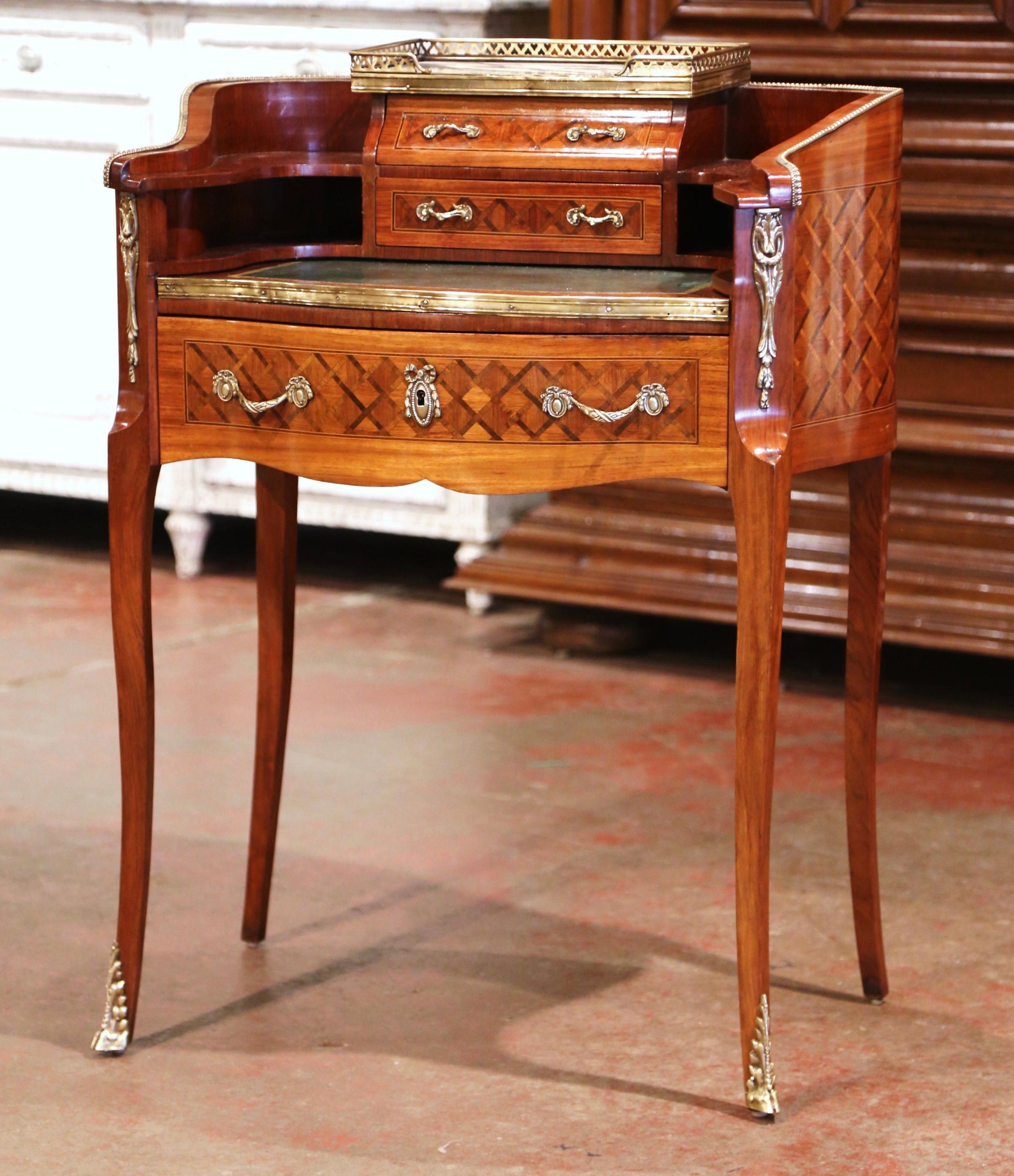 Decorate a study or boudoir with this elegant antique lady’s desk. Crafted in France, circa 1900, the cabinet shaped as a kidney stands on carved cabriole legs ending with bronze mounts over the feet; the delicate piece features a grey marble top