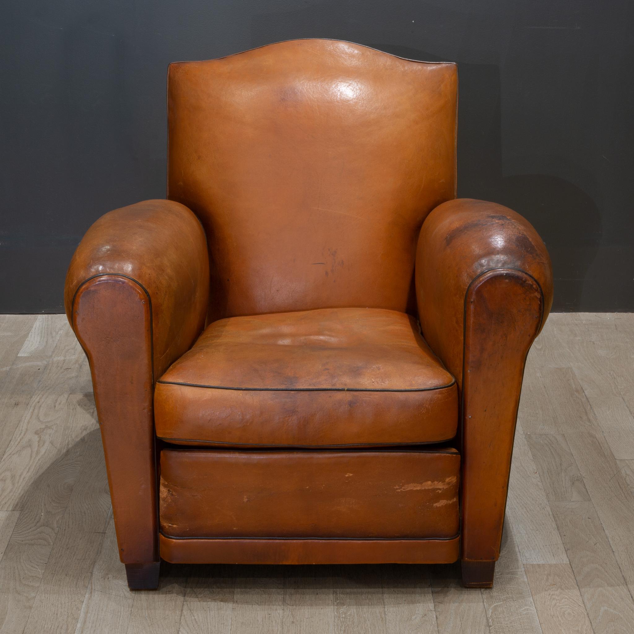 About

Early 20th century French sheep hide leather lounge chair with mustache top, riveted back, wooden feet, black piping and rounded armrest. Partially reconditioned. Very comfortable. This chair has retained its original finish with some