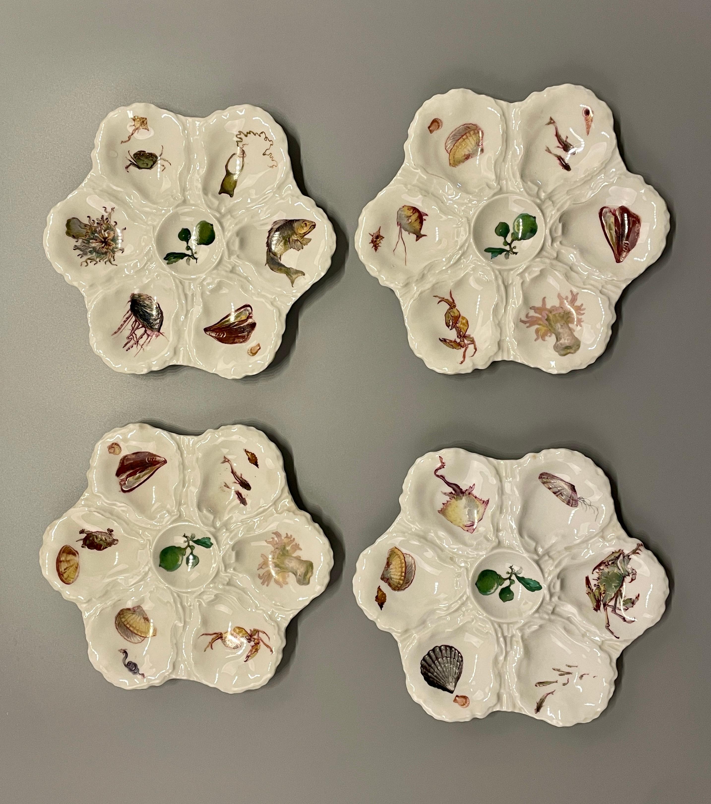 A early 20th c. set of four porcelain oyster plates for Haviland - Limoges having each six oysters shells with a center the sauce well. All in good condition with no chip. Mark on the verso. Circa 1920's.  Dimension 9