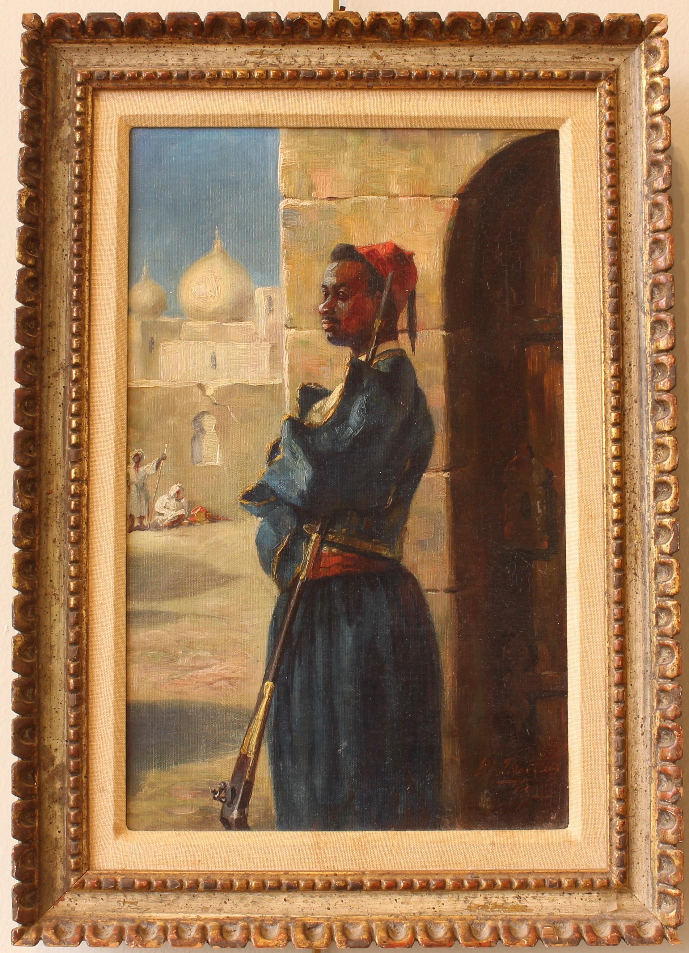 An early 20th century French oil on canvas portrait of a bedouin soldier in carved and painted wood frame signed and dated lower right.
