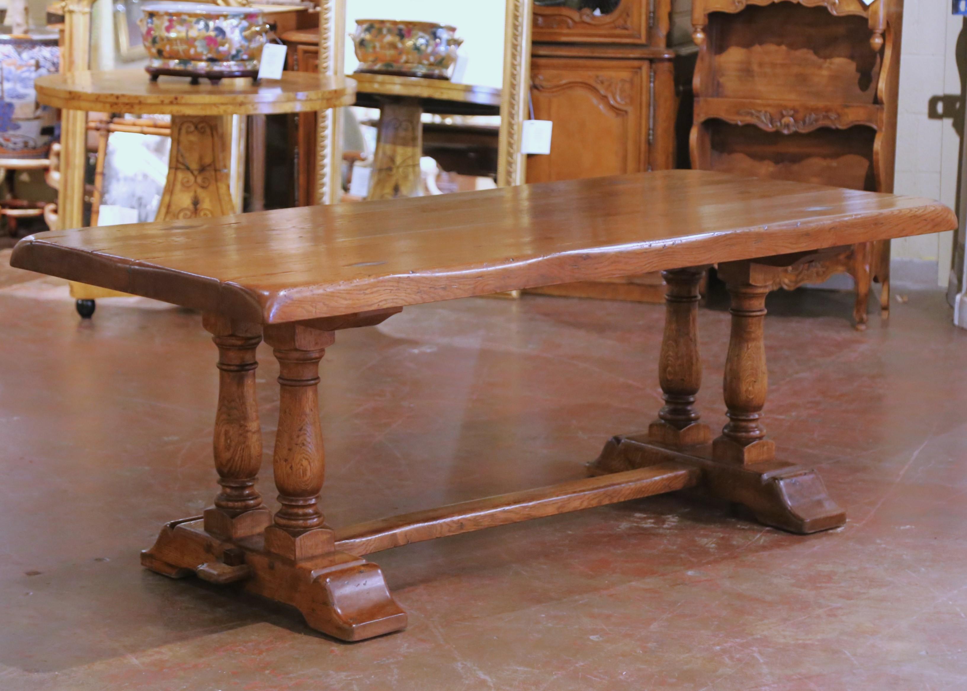Bring rustic warmth and timeless craftsmanship to your dining space with this antique solid oak farm table from France, circa 1920. Crafted in the Louis XIII style, the rectangular planked top, nearly three inches thick, features wonderful surface
