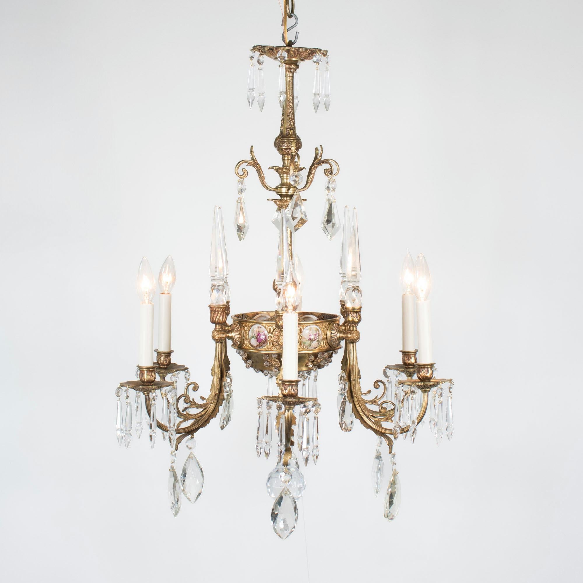 Ce lustre de style rococo à six branches en bronze doré et cristal présente des plaques de porcelaine inspirées des œuvres de Jean-Honoré Fragonard, célèbre peintre rococo français. Le style rococo est célébré pour ses éléments ornés, ses courbes