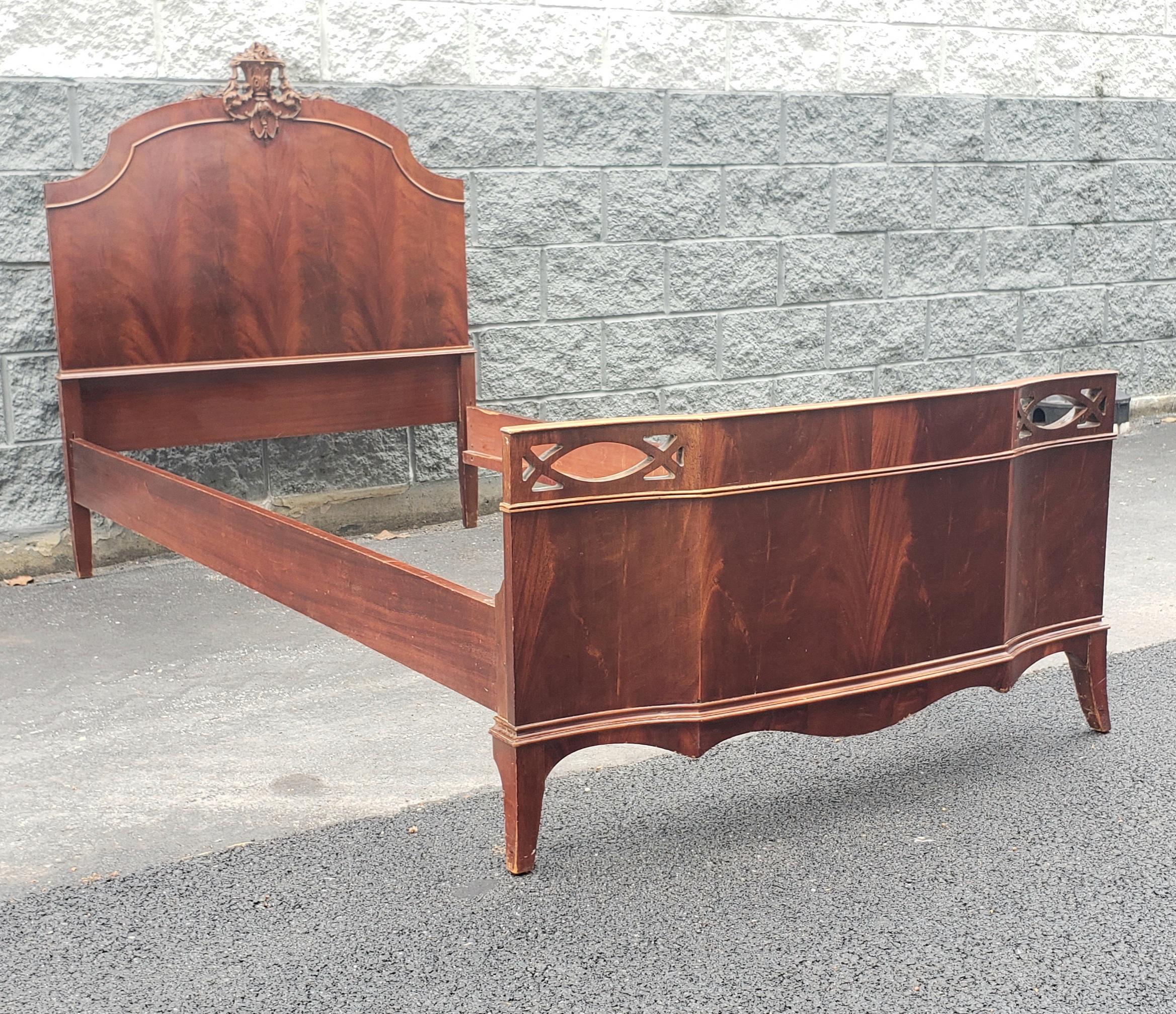 A early 20th century George III Style Carved Crest and Flame Mahogany Twin Bed in good and sturdy antique condition.