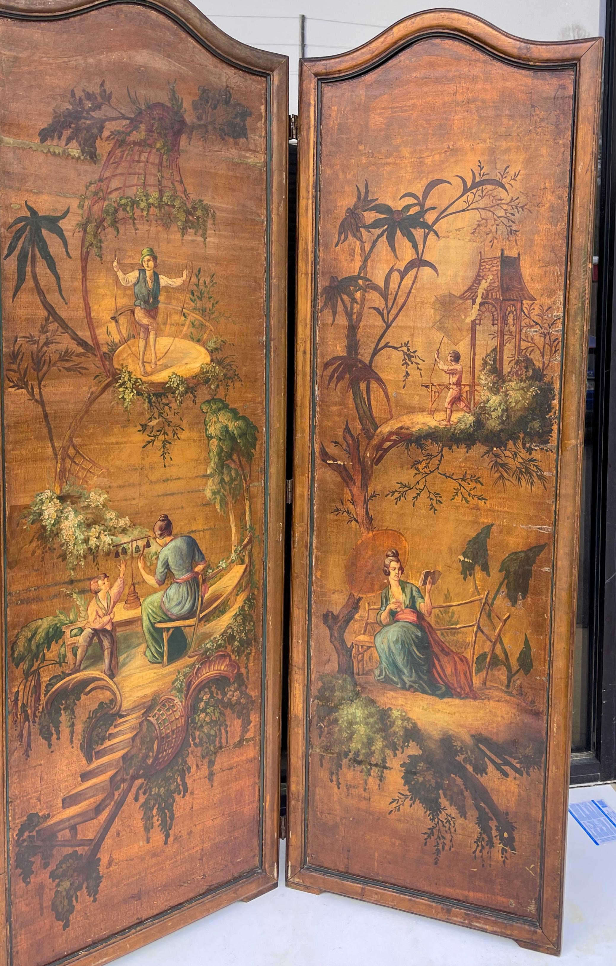 This is an early 20th century French hand painted chinoiserie folding screen. It has three panels and looks wonderful mounted on a wall as well. The piece does show some age wear.