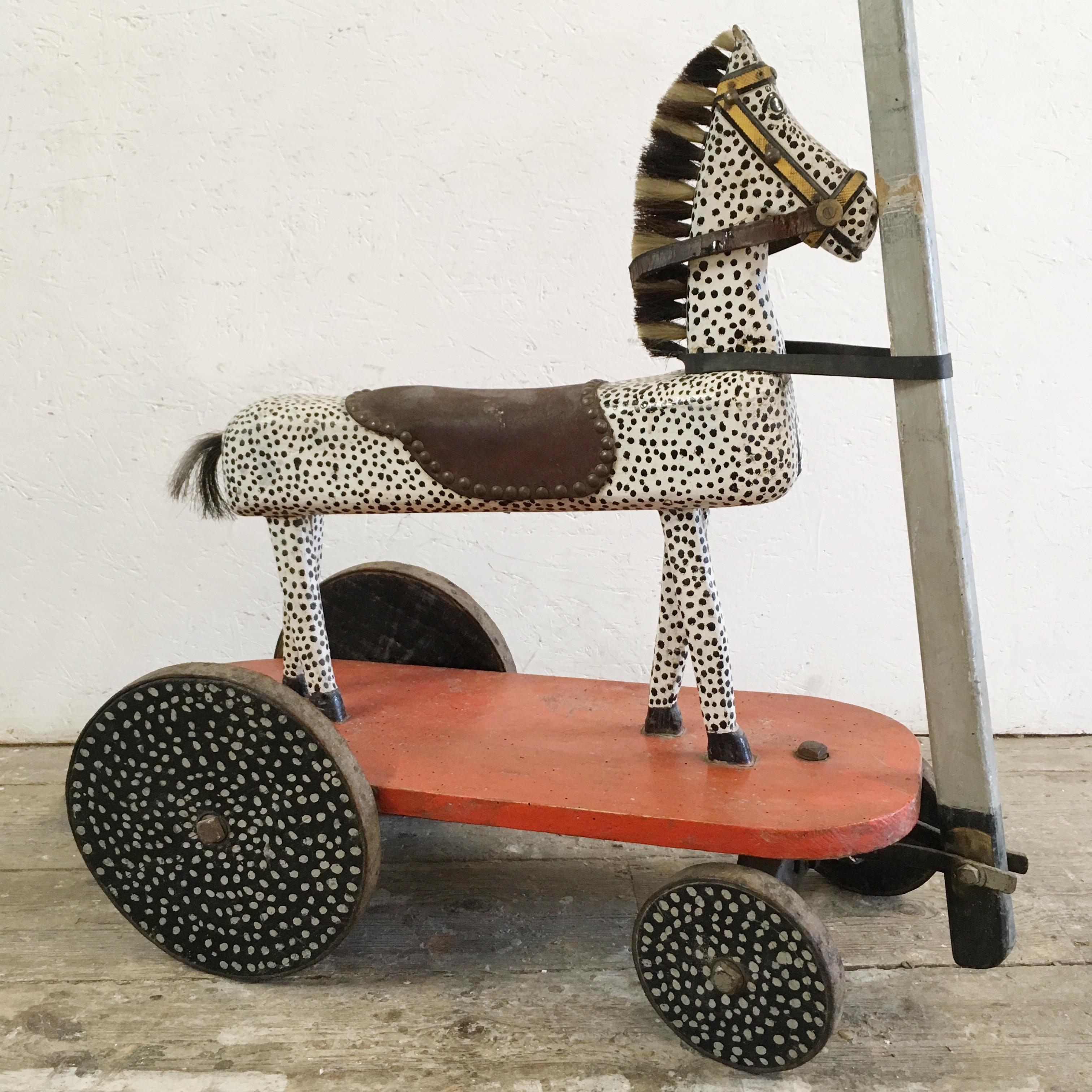 Handcrafted French childs pull along wooden horse.
Fantastic hand painted spotty wooden horse on wheeled base, pull along handle.
The wheels have also been painted spotty in black and white, opposite to the horse,
circa 1930s-1950s.
The horse