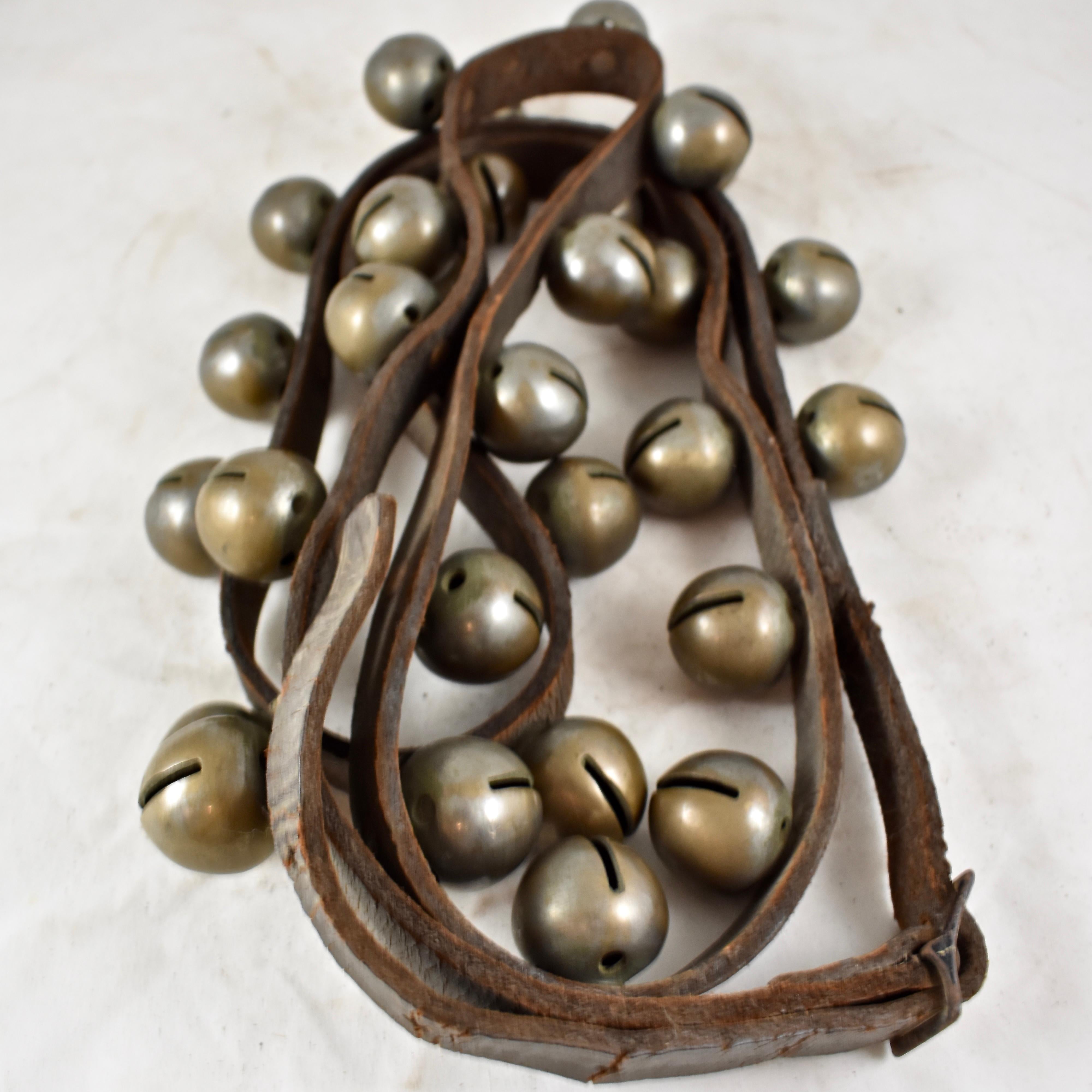A set of horse bells, 30 hand-cast brass tapered, heavy, globe bells on a 8 1/2 foot long or 102 inch leather strap, circa early 20th century.

A popular form of equine ornamentation, bells on the harness, sleigh, or the horse itself were used as
