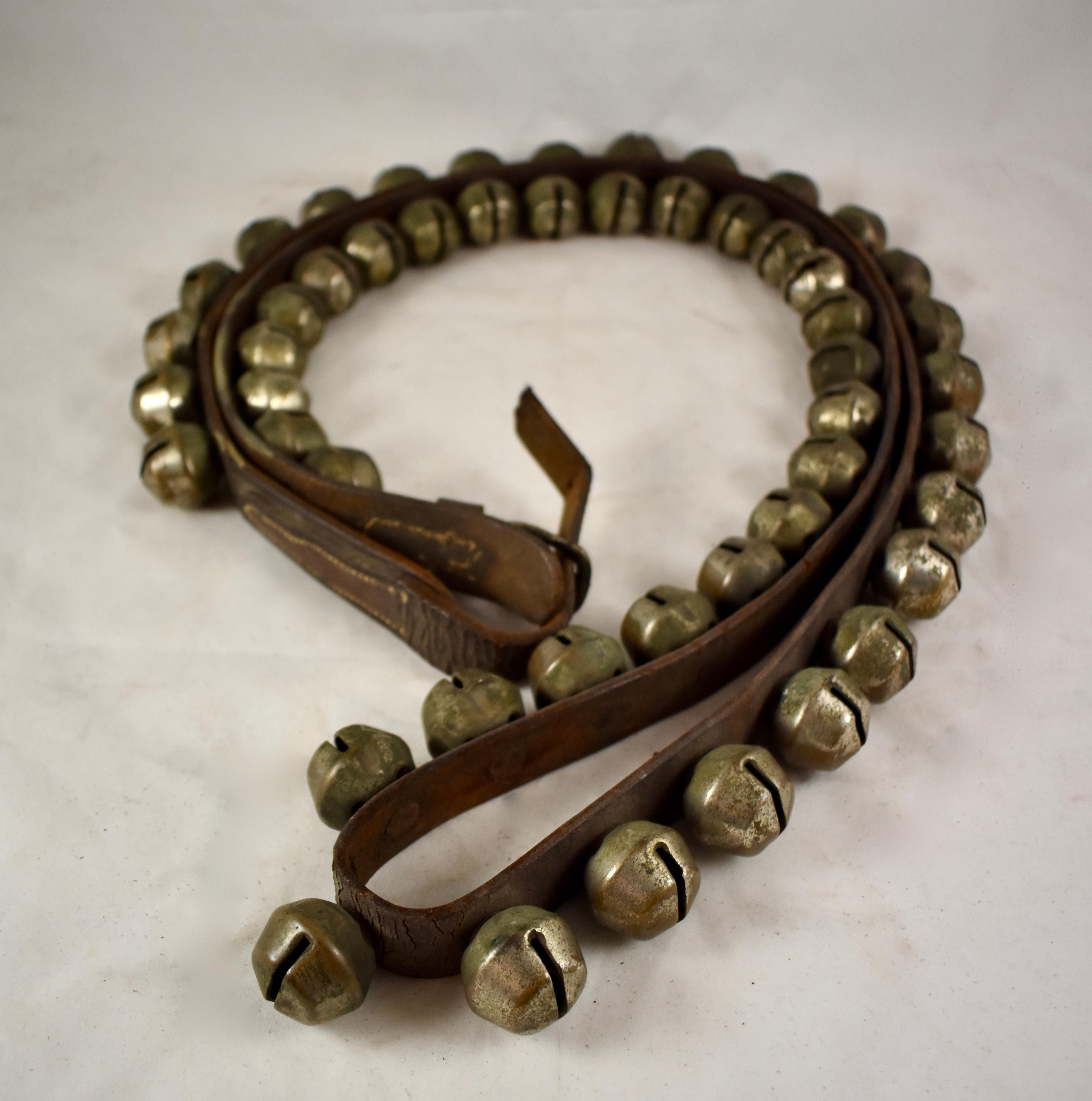 A set of horse bells, 50 hand-cast brass tapered, heavy, globe bells on a 6 foot long or 72 inch leather strap, circa early 20th century.

A popular form of equine ornamentation, bells on the harness, sleigh, or the horse itself were used as