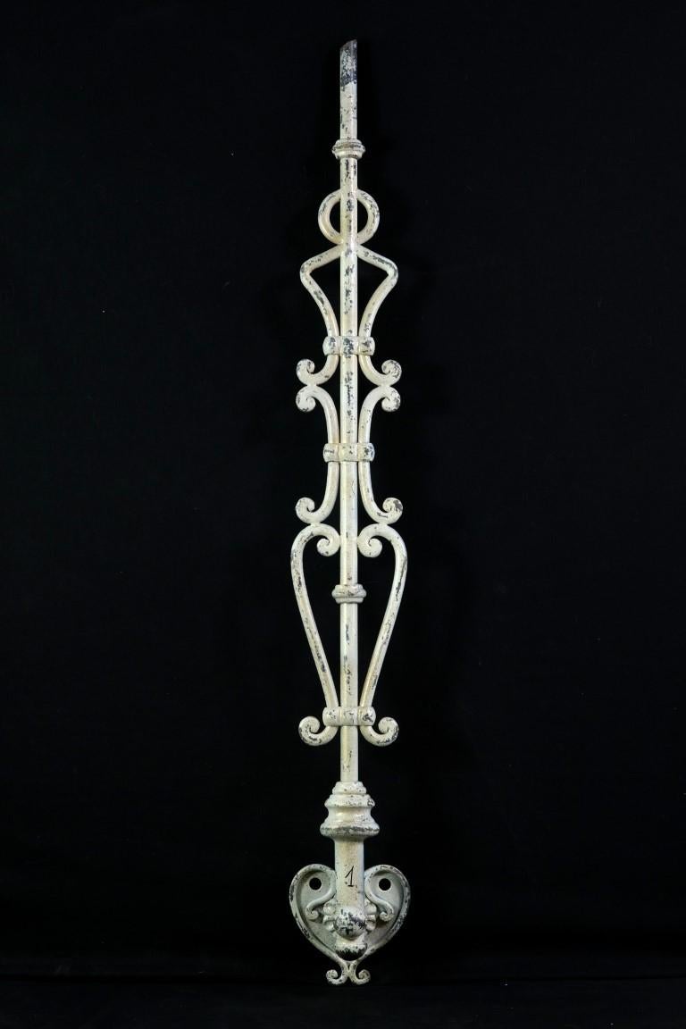 Early 20th Century single one stair balustrade. Made from wrought and cast iron. Attaches to a wall by the bottom heart shaped bracket. White on one side and black and gold on the other.