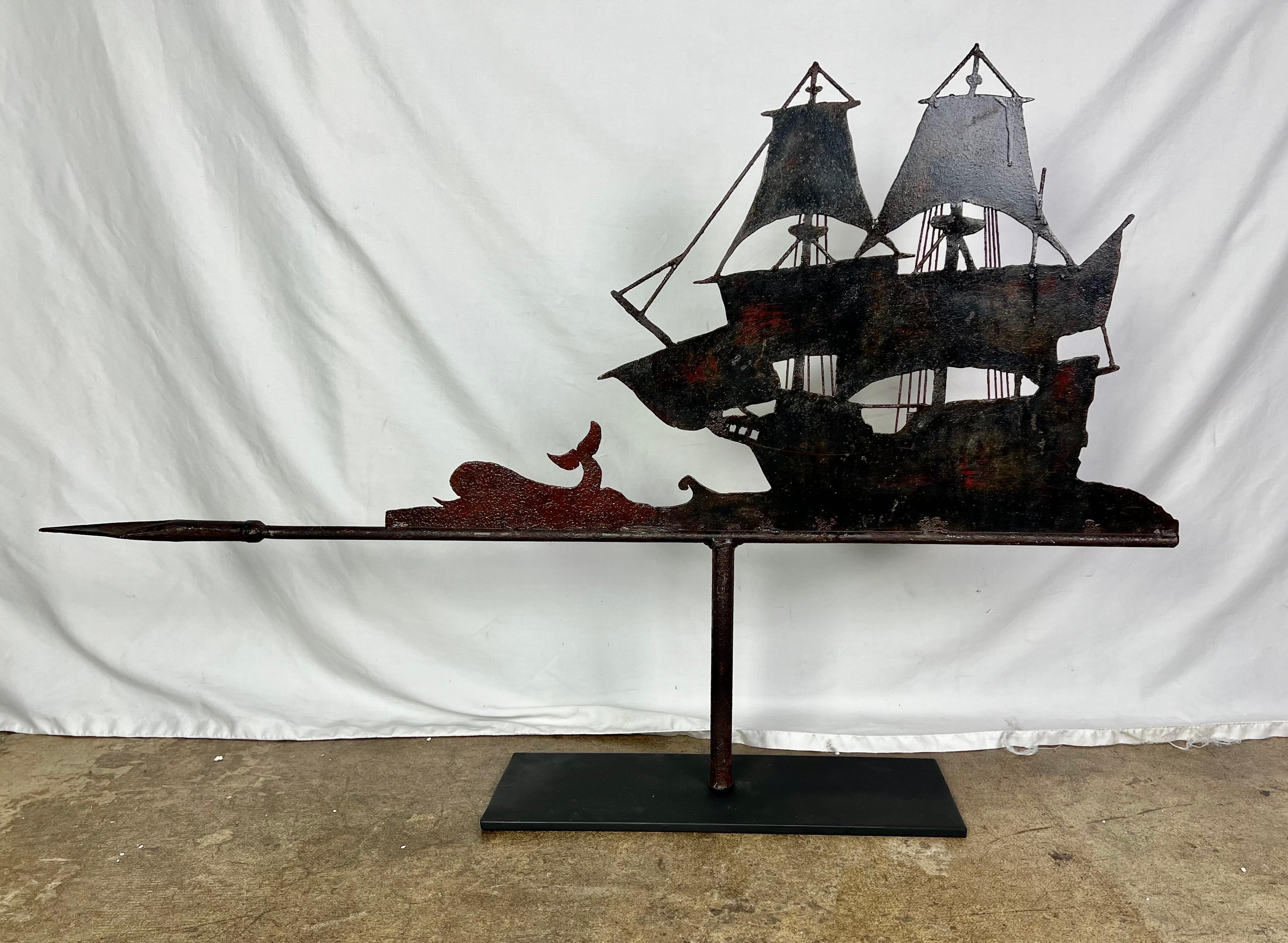Unique and interesting wrought iron ship with a whale.  It is mounted on an iron base.  The piece was originally a weathervane but no longer has it's directionals.  It is a great decorative item to place on a fireplace mantel.  It always seems to