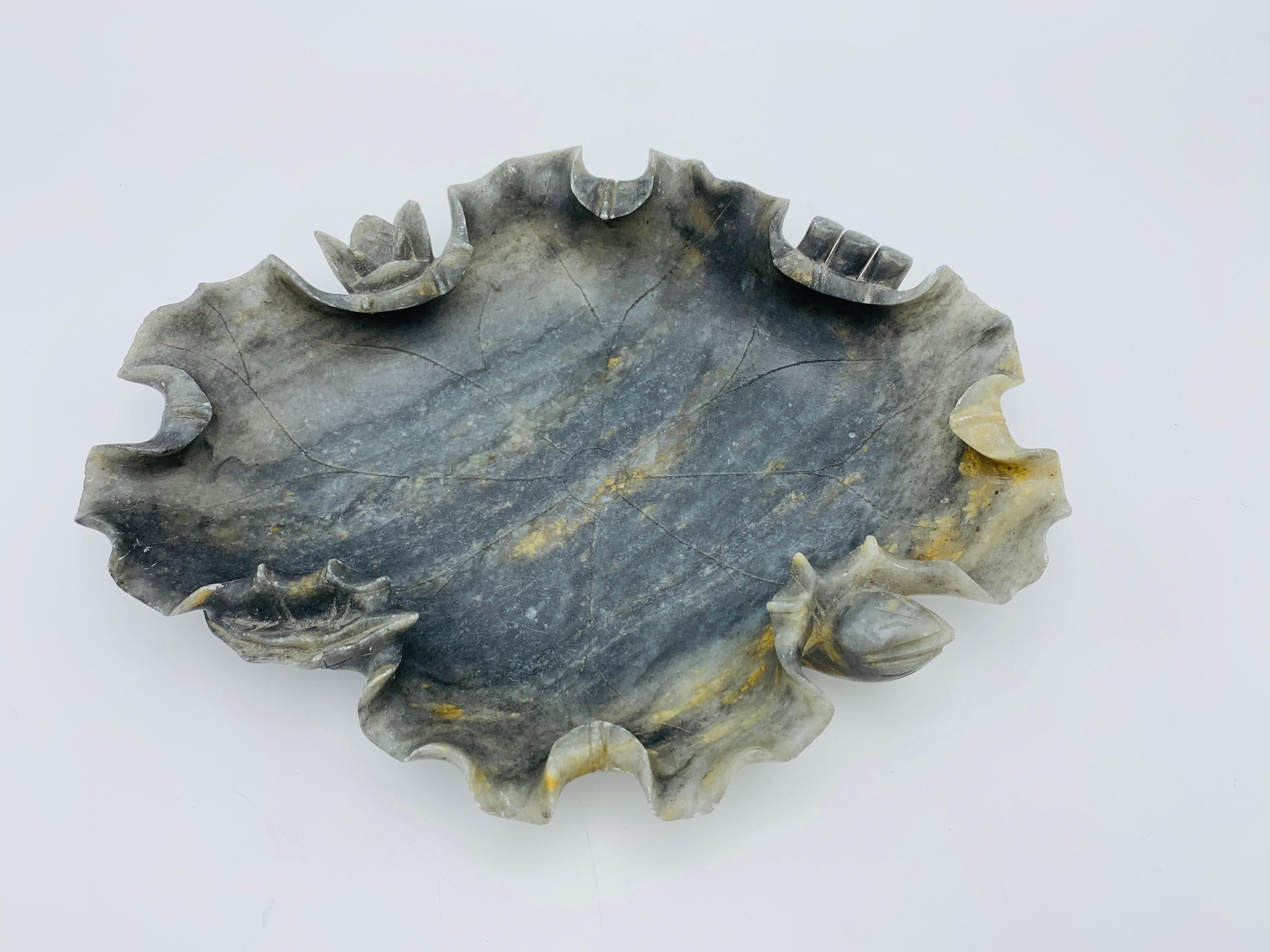 Listed is an absolutely stunning and rare, early 20th century. Italian dark alabaster sculptural lotus leaf dish. This hand carved piece has beautiful, natural veining all-over with heavily detailed edges of the 'leaf'. Incredibly gorgeous in