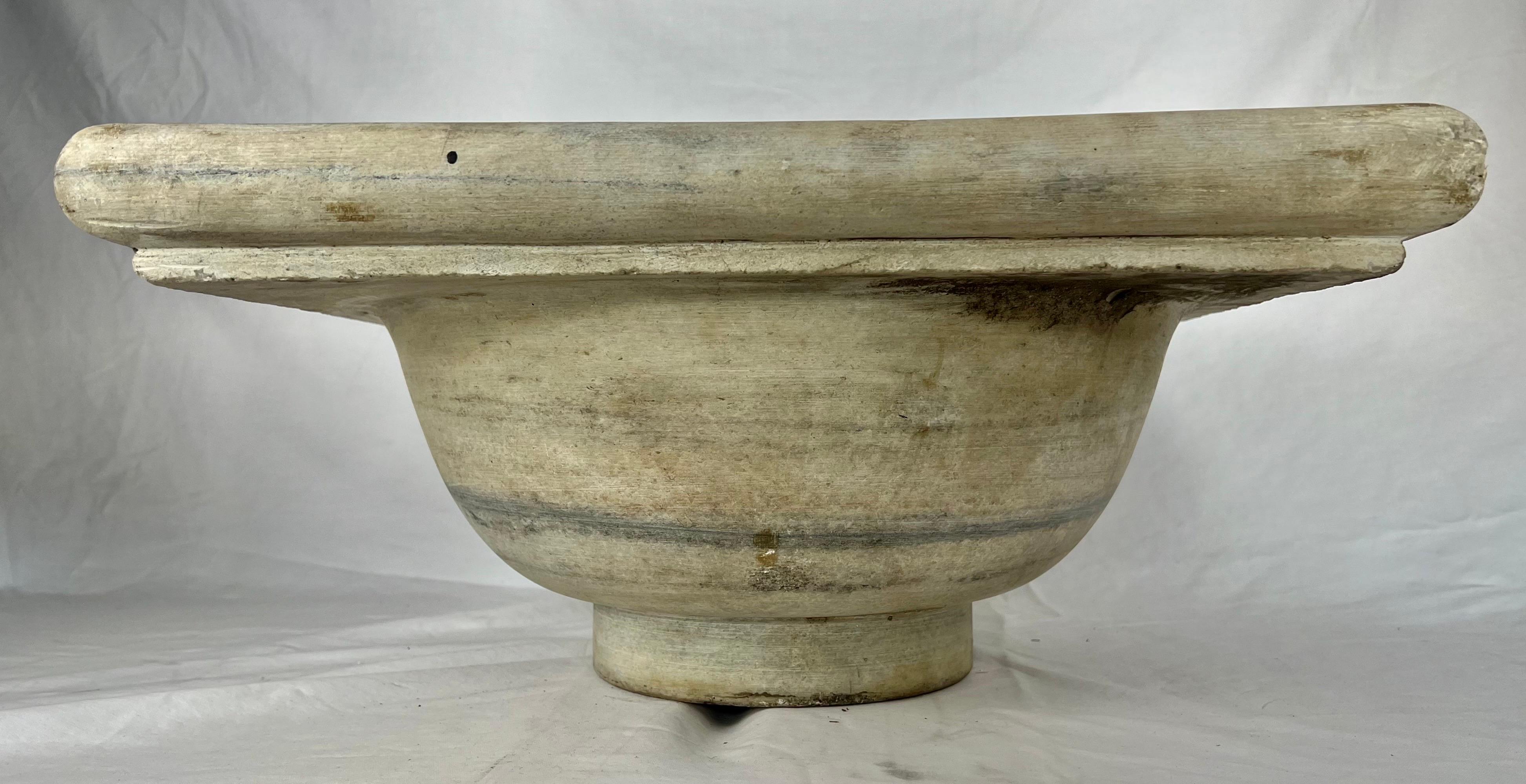 Early 20th century square shaped Italian limestone sink with drain hole.