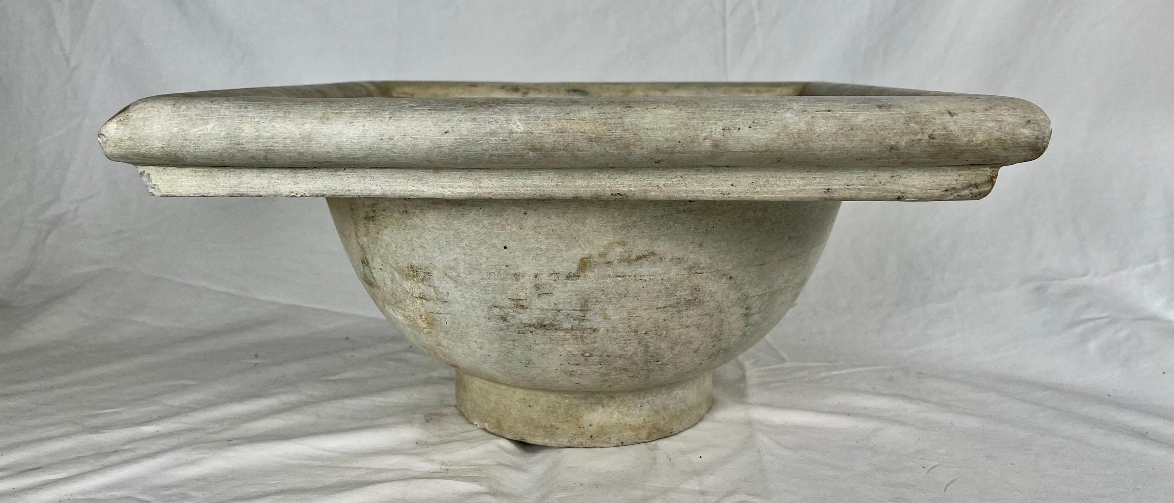 Italian early square shaped 20th century limestone carved sink with drain hole.  
