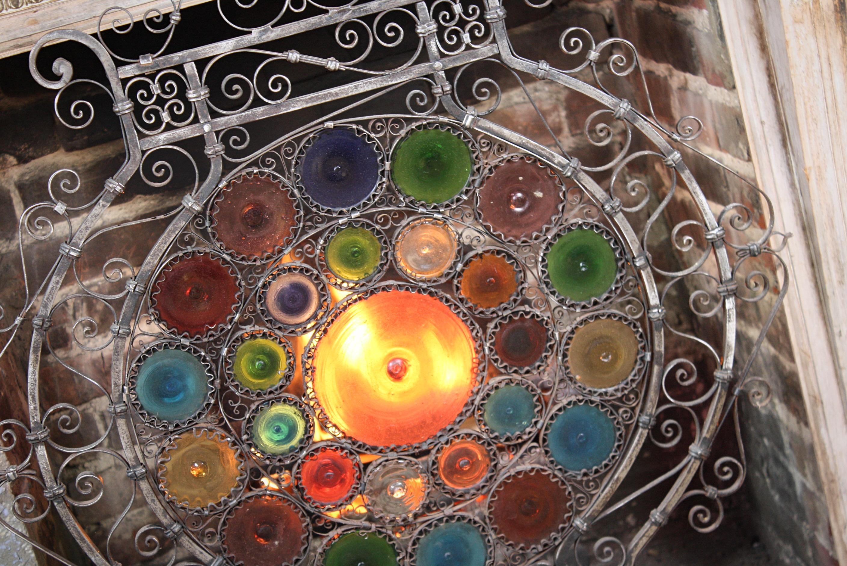 A very imposing and highly decorative free standing fire guard, constructed from a pliable wroughtiron which has been hammered, rolled and then worked while hot enough to remove the slag. This technique gives the blacksmith the ability to form