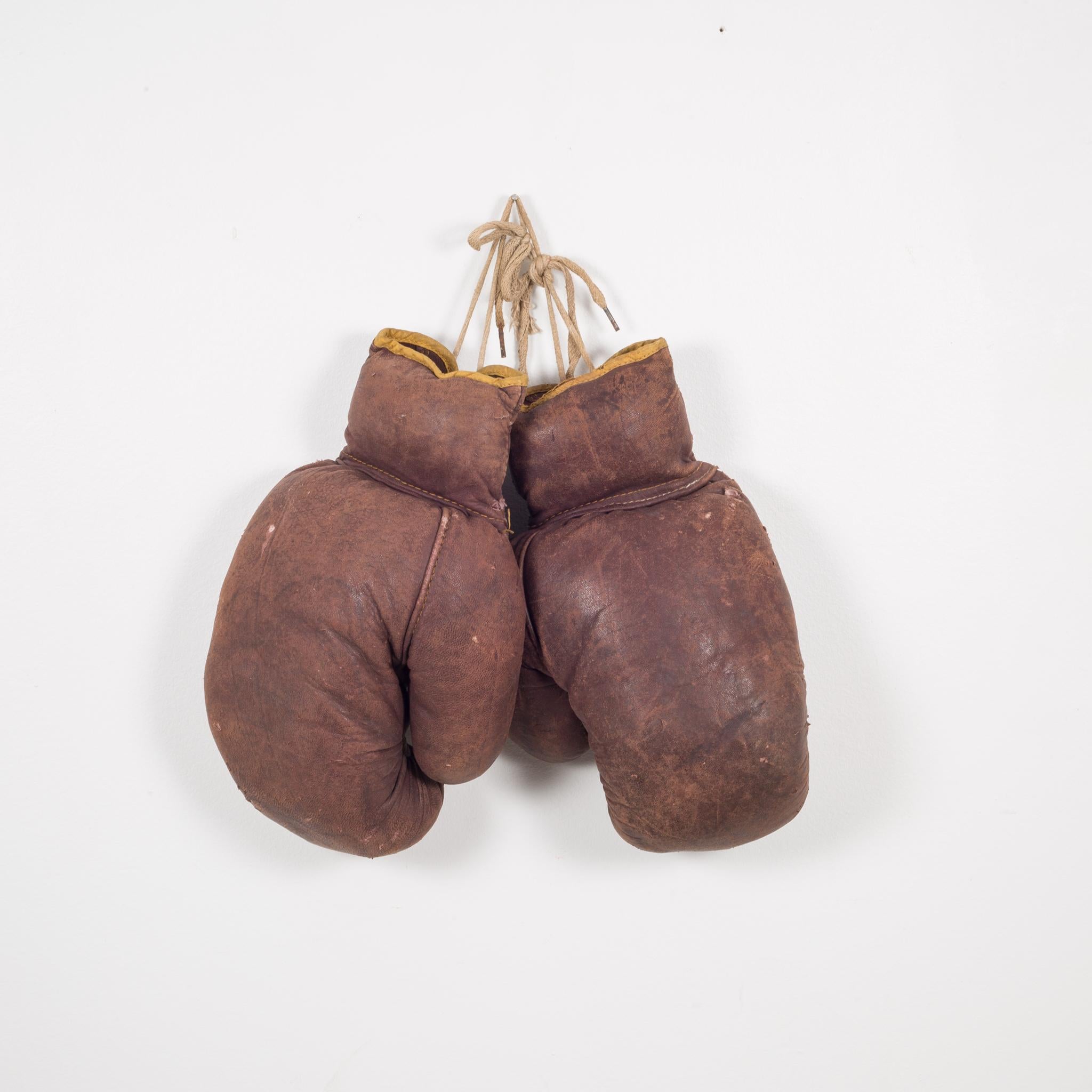 About

This is a original pair of vintage boxing gloves with brown leather and gold leather trim. Each glove has retained it's original color with minor blemishes on the leather.

Creator Unknown.
Date of manufacture circa 1940
Materials and