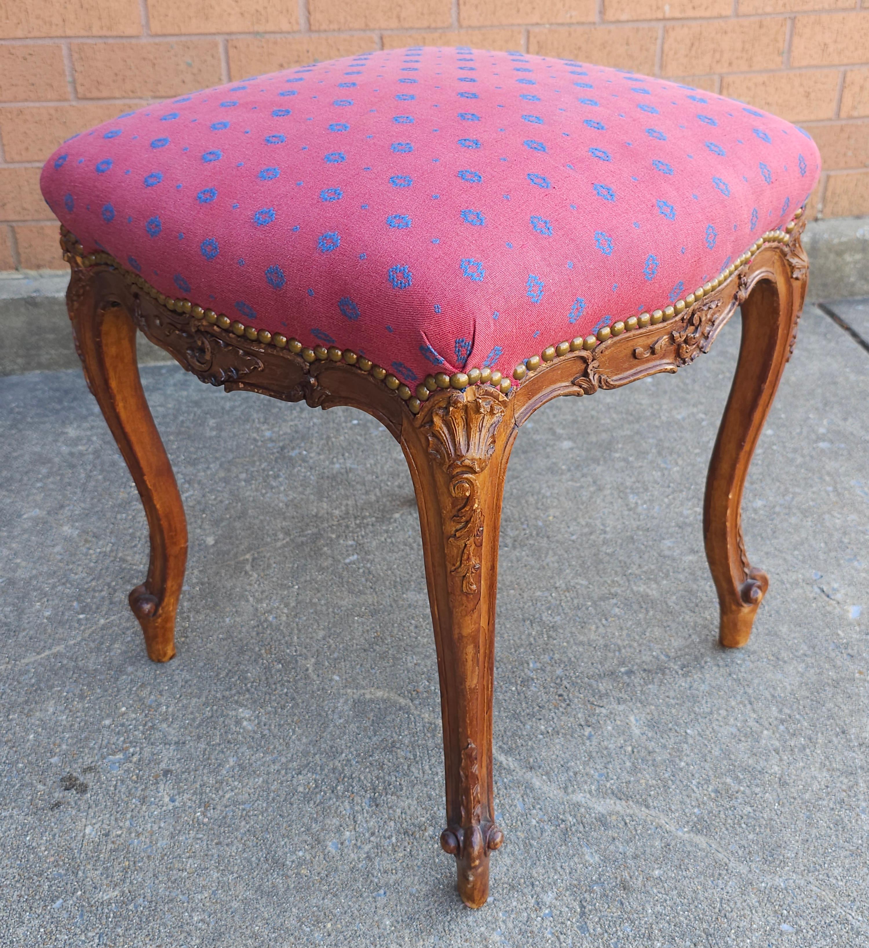 A gorgeous Early 20th C. Louis XV Carved Fruitwood Brass Nail Studded And Upholstered Bench.
Newer upholstery in great vintage condition.
Measures 18