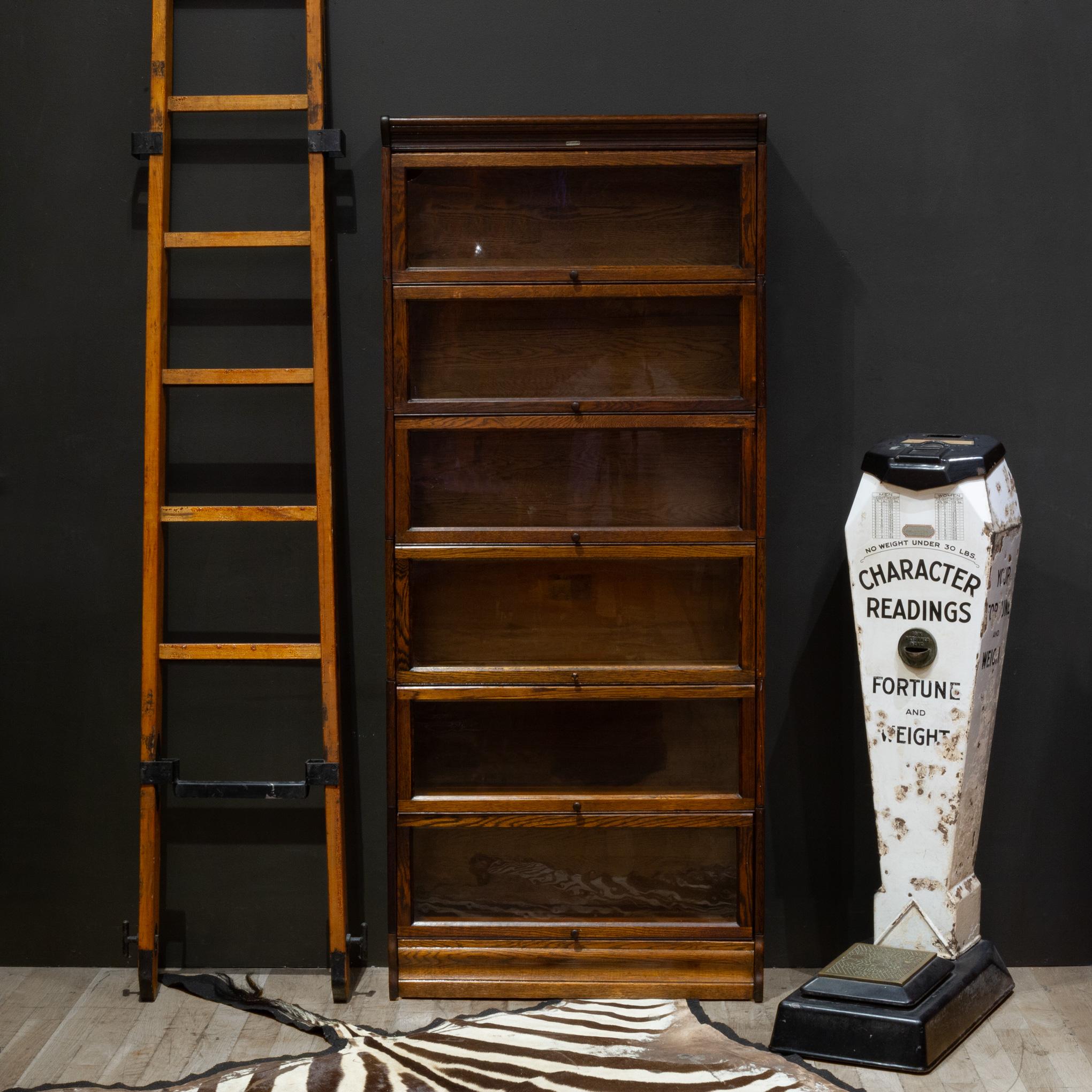 ABOUT

An original 6 stack Oak lawyer's bookcase with glass doors that open and slide in from the top. Wooden knobs. The whole piece is modular consisting of eight pieces: the top, the bottom and six cabinets that all interlock. Original metal label